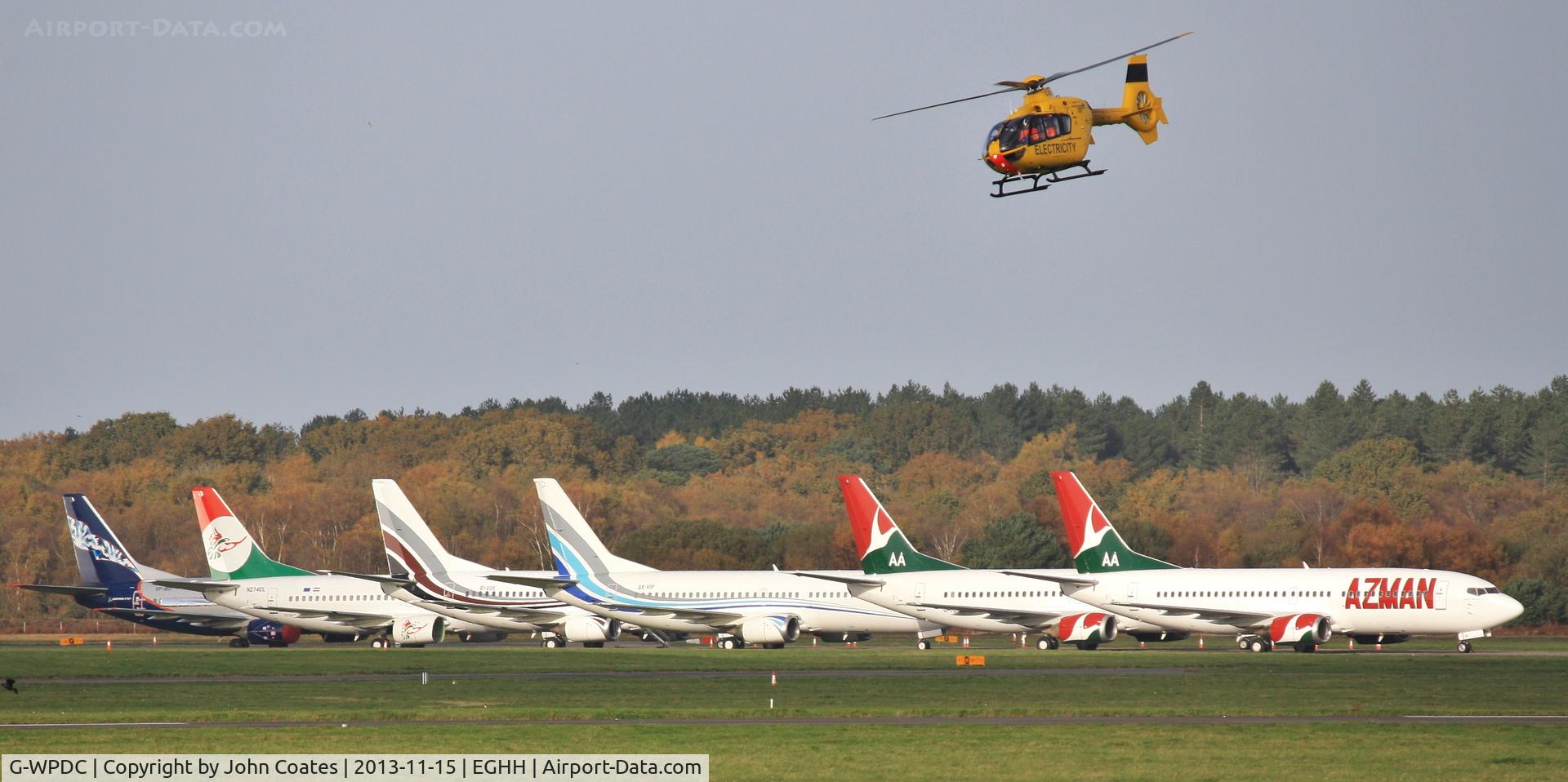 G-WPDC, 1999 Eurocopter EC-135P-1 C/N 0090, Departing past an impressive line of 737s at European Aviation