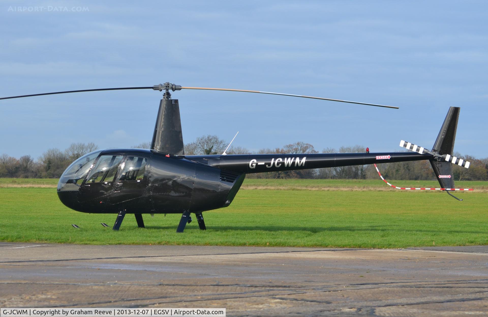 G-JCWM, Robinson R44 II C/N 11860, Parked at Old Buckenham.