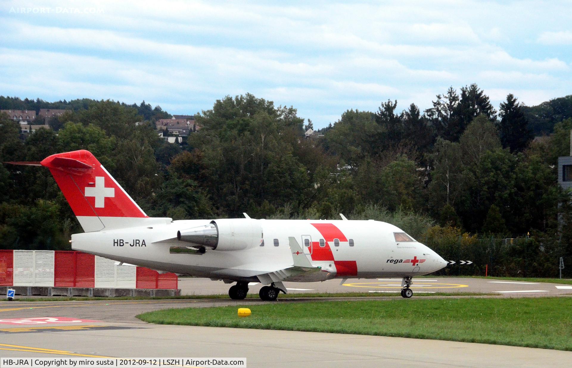 HB-JRA, 2002 Bombardier Challenger 604 (CL-600-2B16) C/N 5529, Swiss Air Rescue (Rega) Bombardier airplane after landing at Zurich-Kloten International Airport, photo through airplane window.
