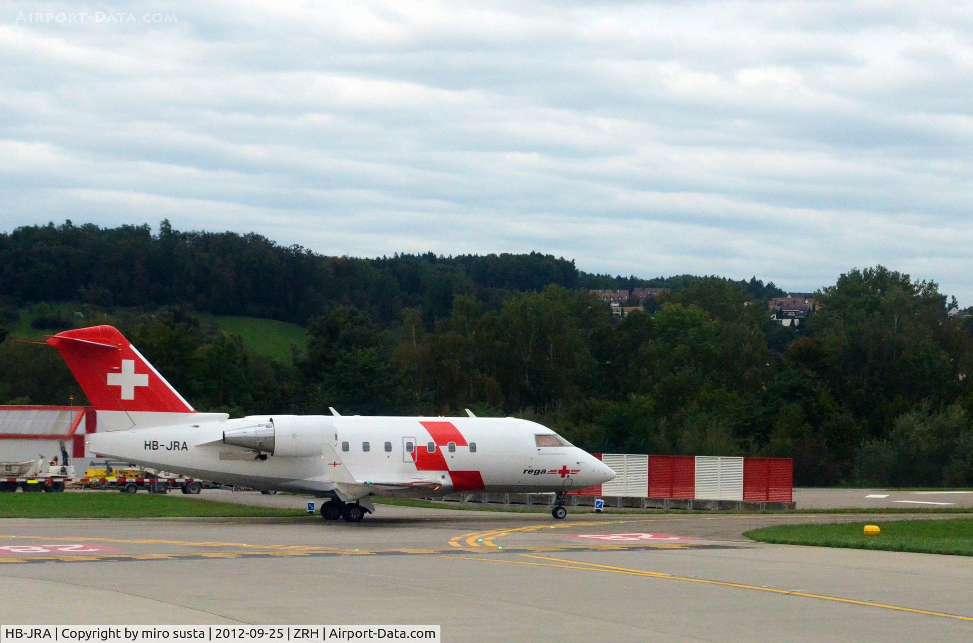HB-JRA, 2002 Bombardier Challenger 604 (CL-600-2B16) C/N 5529, Swiss Air Rescue (Rega) Bombardier airplane after landing at Zurich-Kloten International Airport, photo through airplane window.