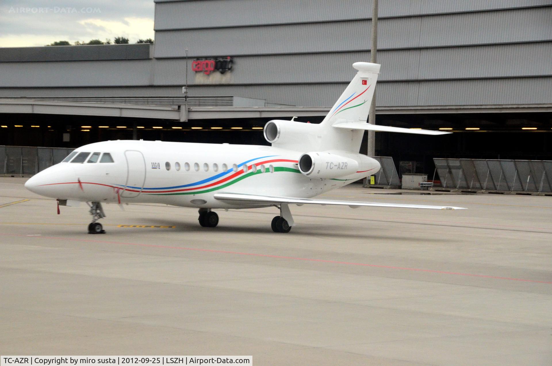 TC-AZR, 2010 Dassault Falcon 900EX C/N 236, Private Dassault Falcon airplane parking at Zurich-Kloten International Airport, photo through airplane window.