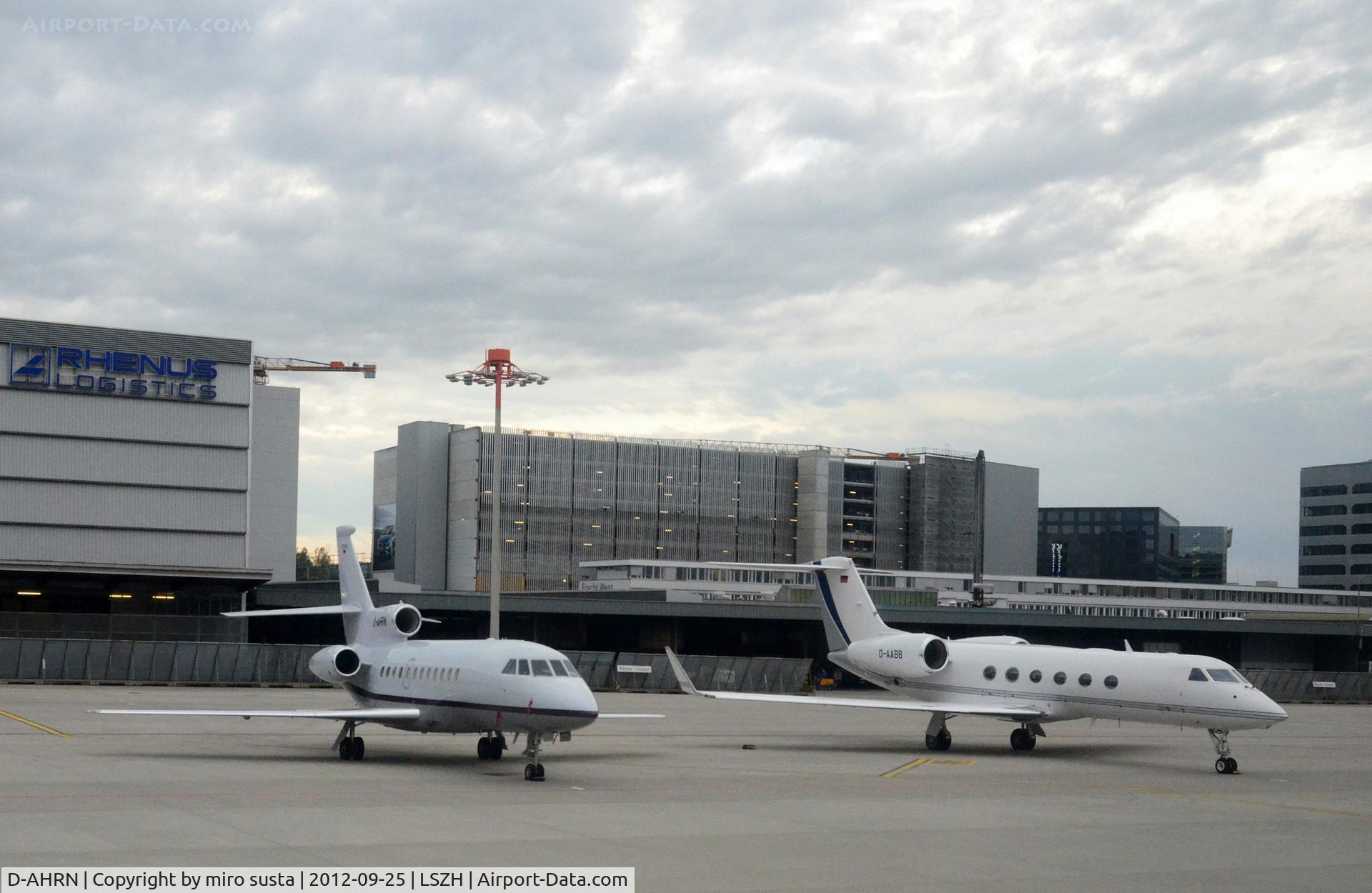 D-AHRN, 2001 Dassault Falcon 900EX C/N 96, Heron Aviation Falcon 900EX and DC Aviation Gulfstream G450 D-AABB) airplanes parking at Zurich-Kloten International Airport, photo through airplane window.