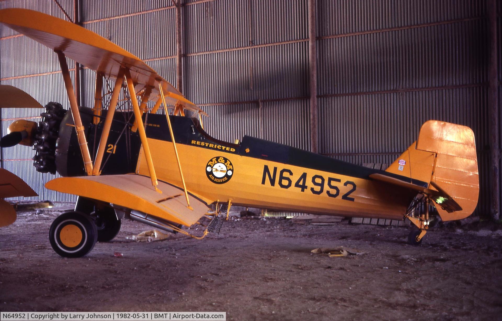 N64952, 1941 Boeing E75 C/N 75-637, An M&M sprayer inside their hanger.  Still open cockpit.