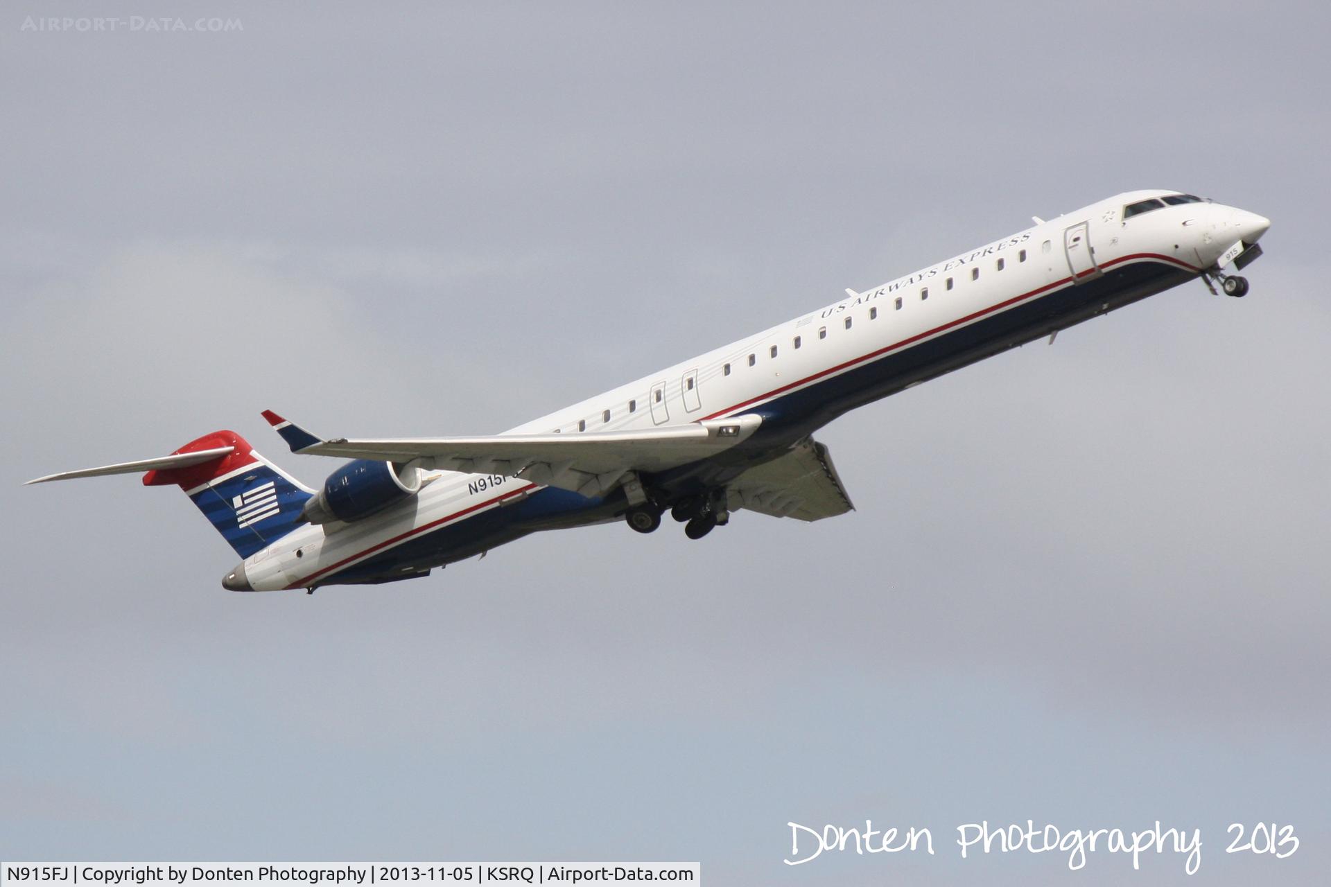 N915FJ, 2004 Bombardier CRJ900 (CL-600-2D24) C/N 15015, US Air Flight 2884 operated by Mesa (N915FJ) departs Sarasota-Bradenton International Airport enroute to Charlotte-Douglas International Airport