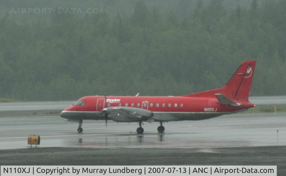 N110XJ, 1988 Saab 340A C/N 340A-110, Taxiing at Anchorage, Alaska, in a heavy rain.