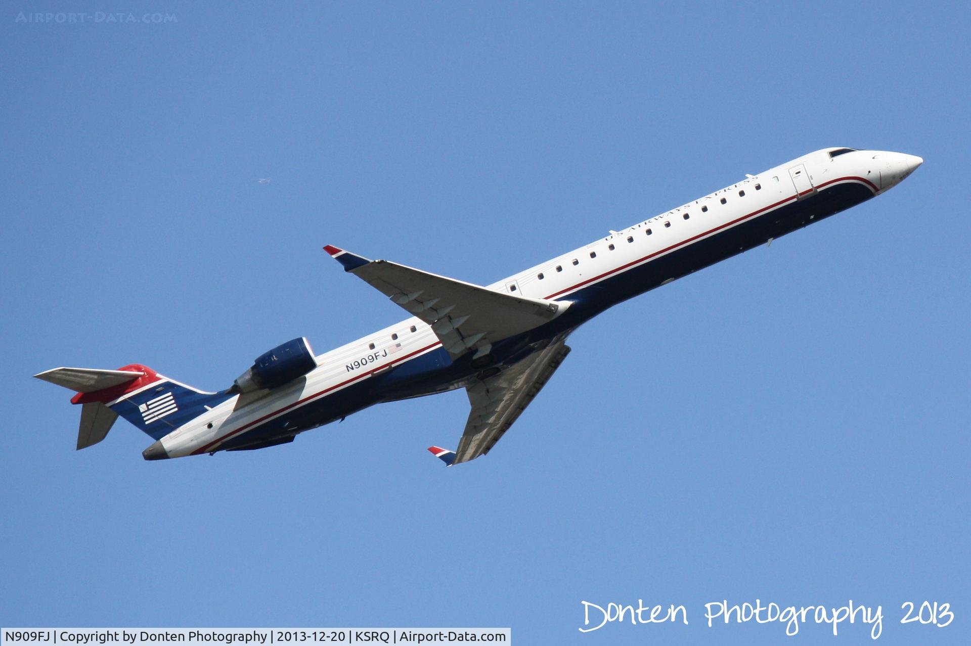 N909FJ, 2003 Bombardier CRJ-900ER (CL-600-2D24) C/N 15009, US Air Flight 2709 operated by Mesa (N909FJ) departs Sarasota-Bradenton International Airport enroute to Charlotte-Douglas International Airport