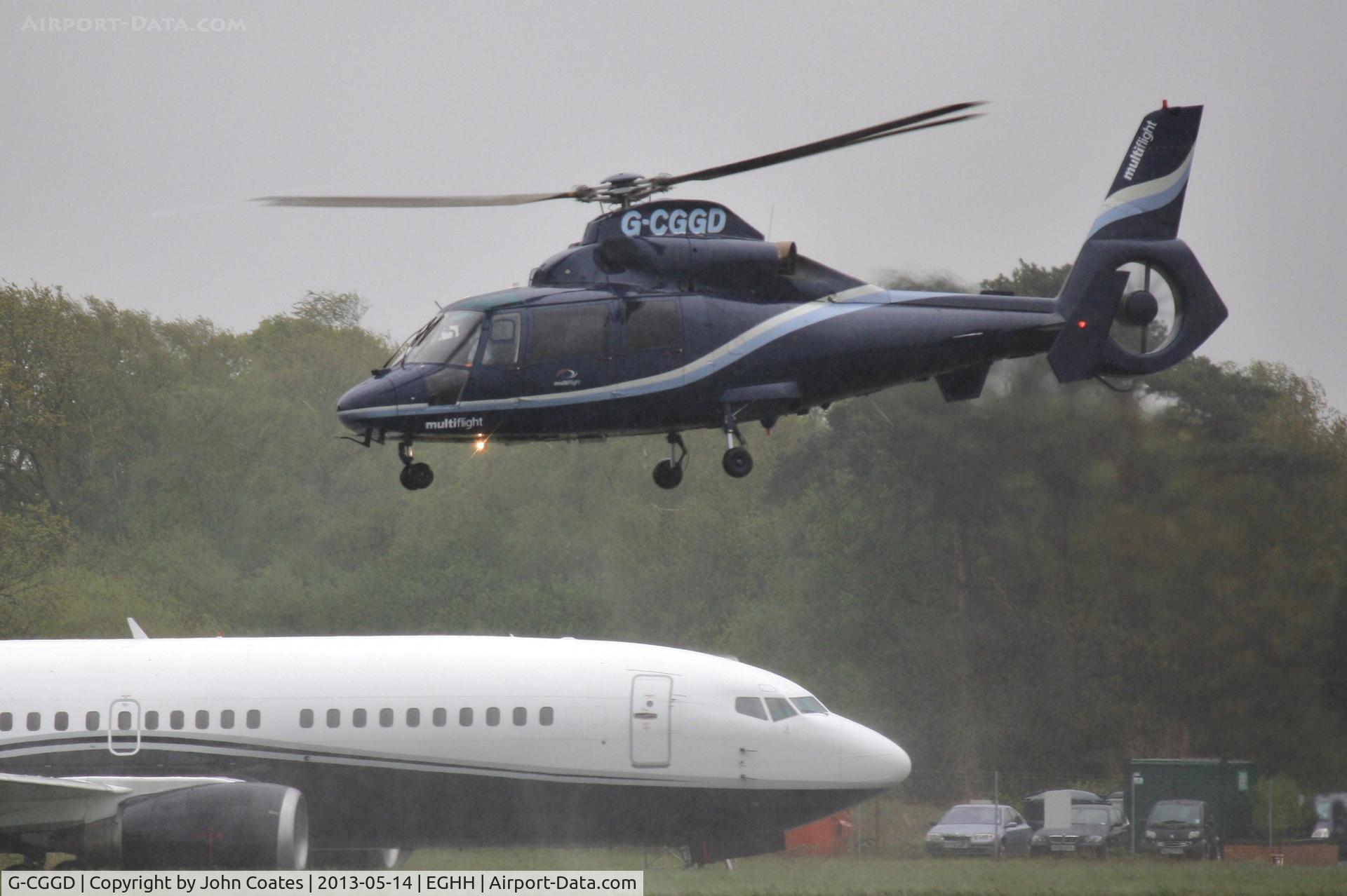 G-CGGD, 1991 Aerospatiale AS-365N-2 Dauphin C/N 6435, Multiflight Dauphin lifts over Multiflight 737 9H-MTF