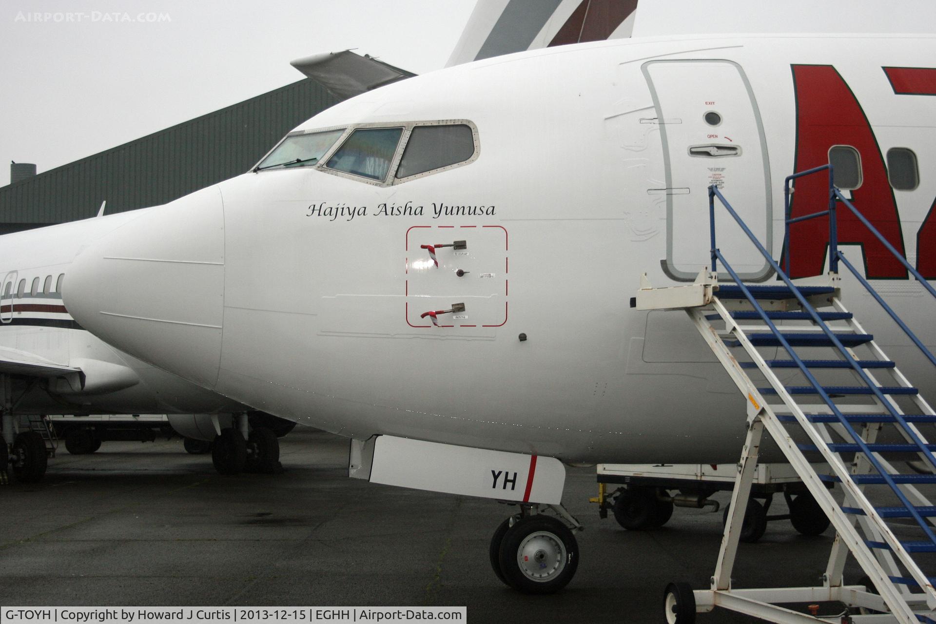 G-TOYH, 1998 Boeing 737-36N C/N 28570, Close up of the nose, with the name 'Hajiya Aisha Yunusa'.