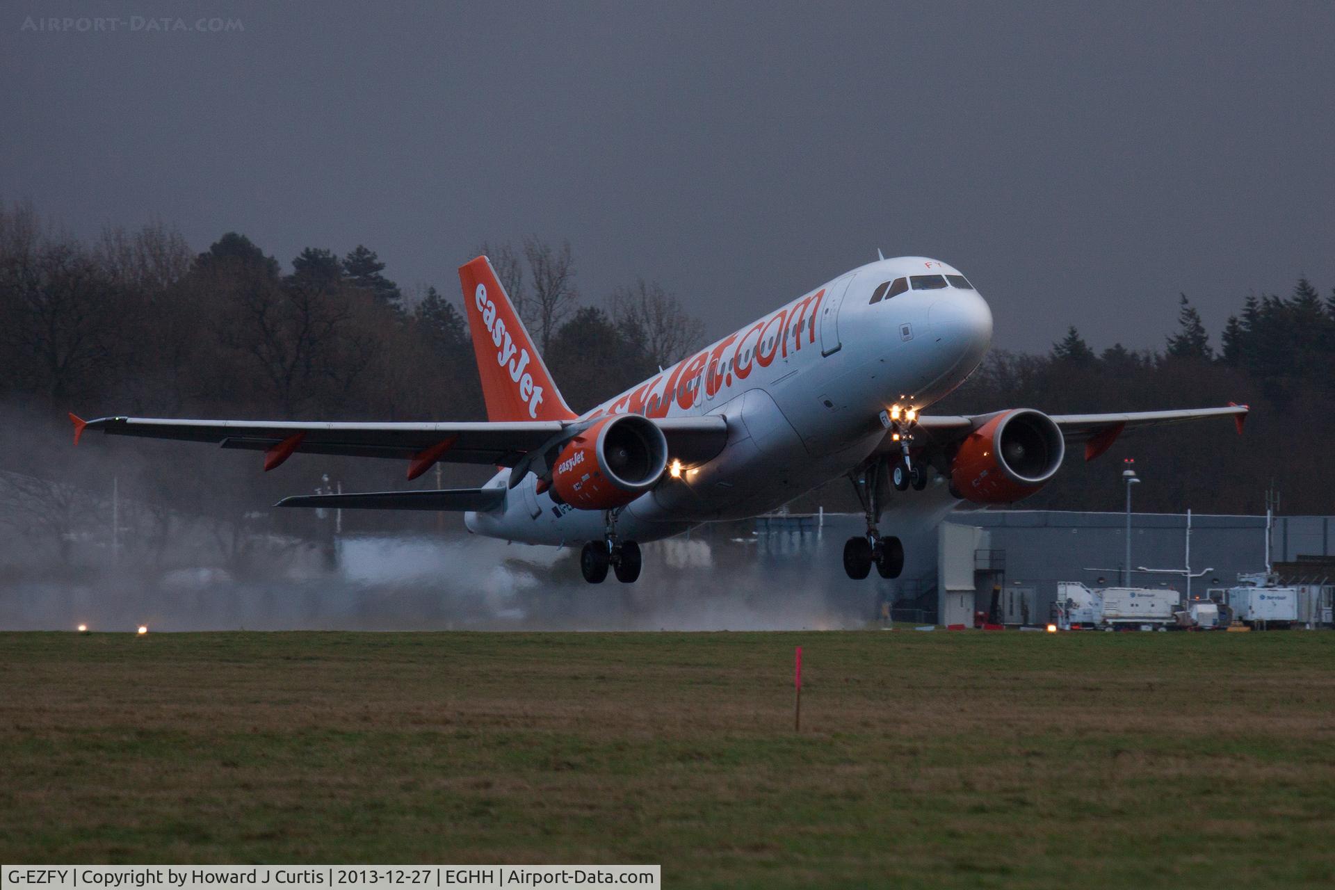 G-EZFY, 2010 Airbus A319-111 C/N 4418, easyJet, lifting off on a dark, rainy day.