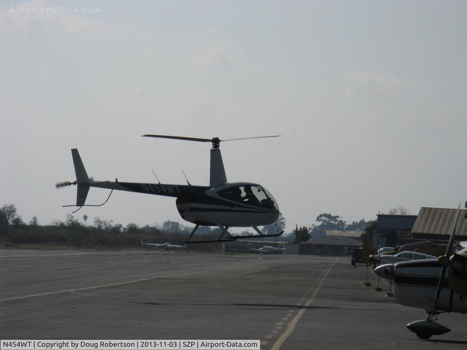 N454WT, 2001 Robinson R44 Raven II C/N 1042, 2001 Robinson R44 RAVEN, Lycoming O-540-F1B5 derated to 205 Hp continuous, crossing Rwy 22 to fuel dock