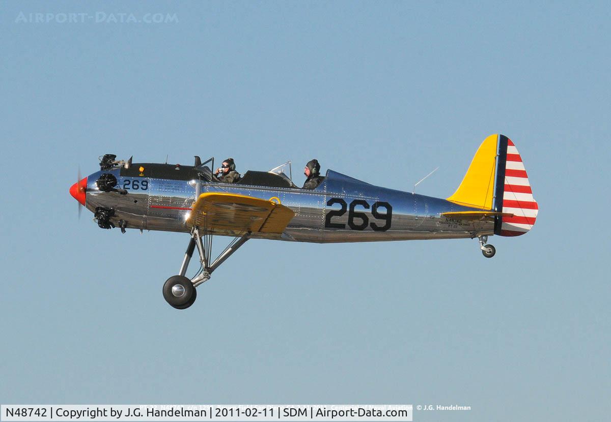 N48742, 1941 Ryan Aeronautical ST3KR C/N 1298, Over Brown Field.