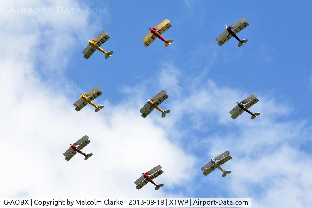 G-AOBX, 1940 De Havilland DH-82A Tiger Moth II C/N 83653, De Havilland DH-82A Tiger Moth II G-AOBX leading the Tiger 9 Formation Display Team at The De Havilland Moth Club's 28th International Moth Rally at Woburn Abbey. August 2013.