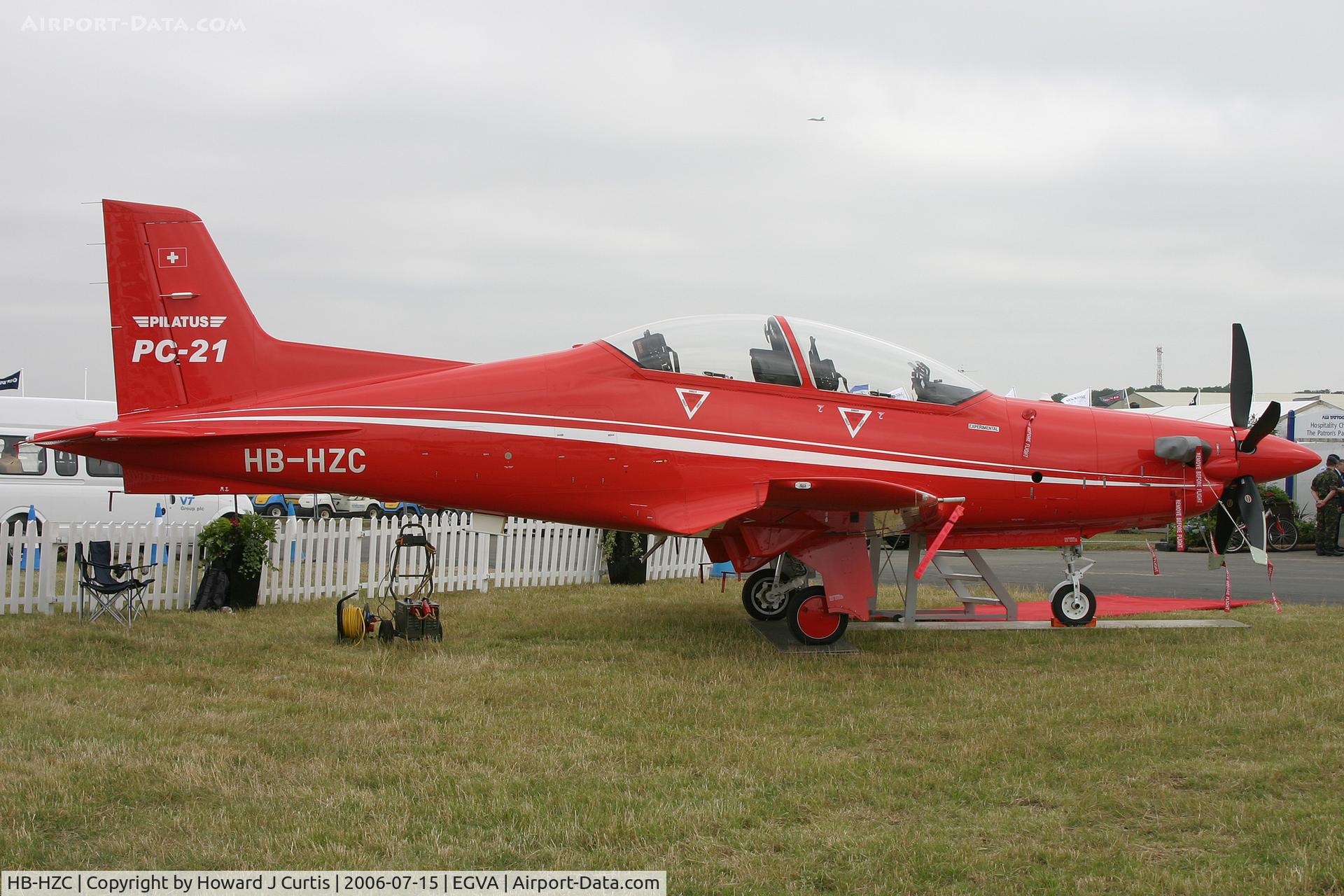 HB-HZC, 2005 Pilatus PC-21 C/N 101, RIAT 2006. On display outside the BAe chalets. FA-18F in the circuit above!