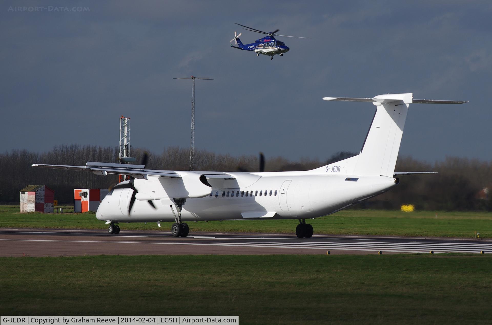 G-JEDR, 2003 De Havilland Canada DHC-8-402Q Dash 8 C/N 4087, About to depart having been resprayed. G-VINJ can be seen in the back ground.