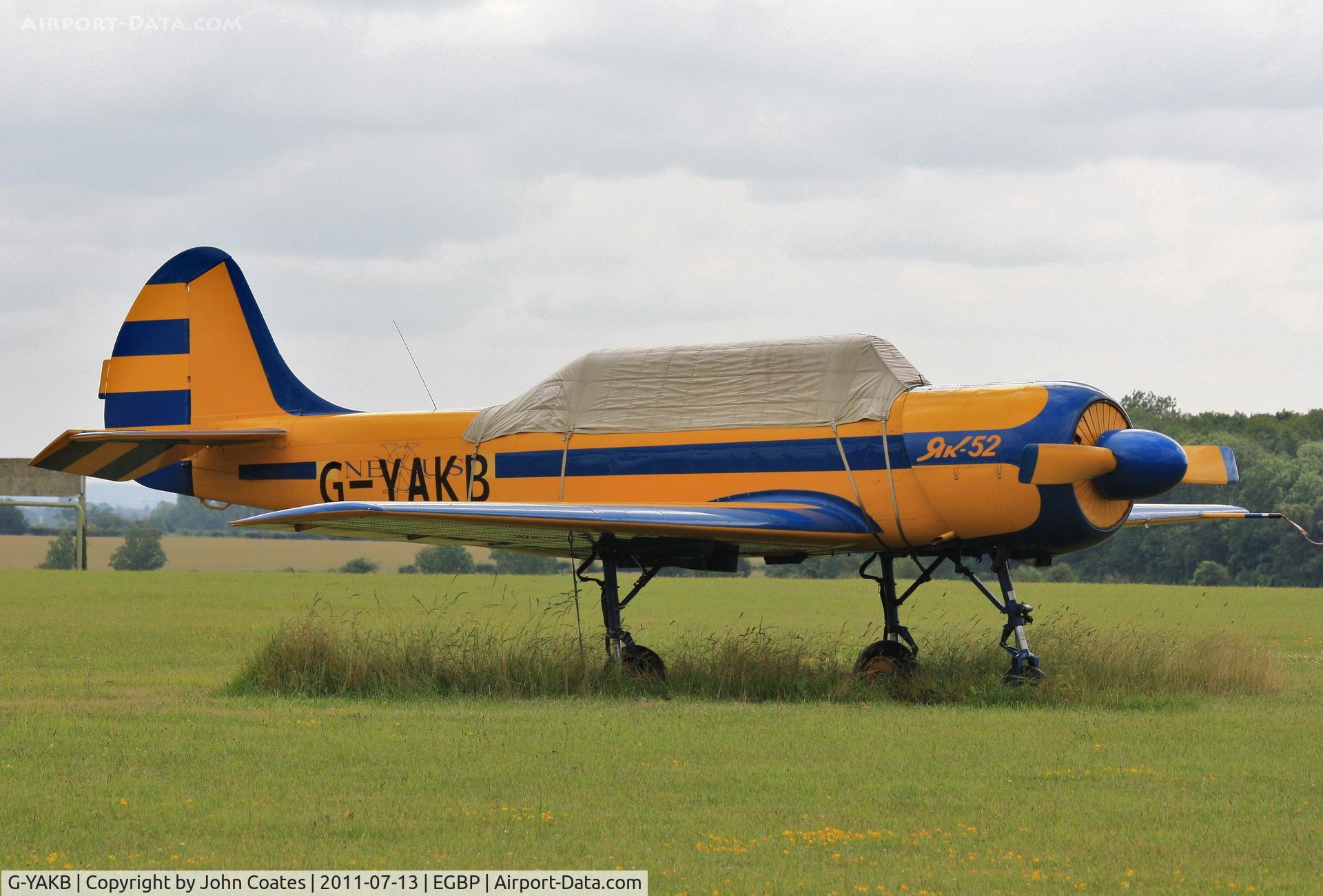 G-YAKB, 1992 Yakovlev (Aerostar) Yak-52 C/N 9211517, Protected from the July weather !