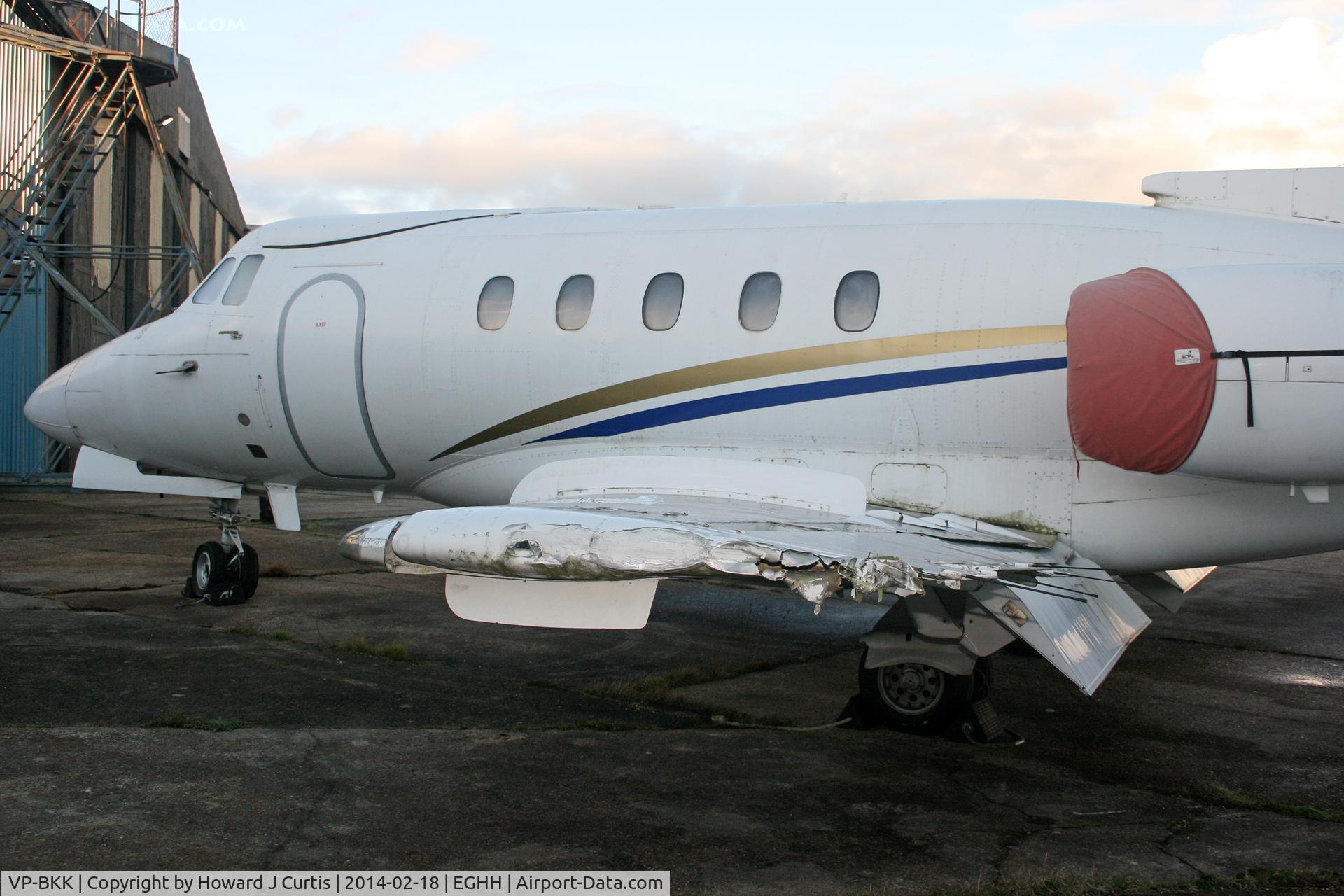 VP-BKK, 1970 Hawker Siddeley HS.125 Series 400A C/N 25238, Close up of the port wing, which was damaged when the aircraft was blown into a fence during the storm on 14/2/2014.