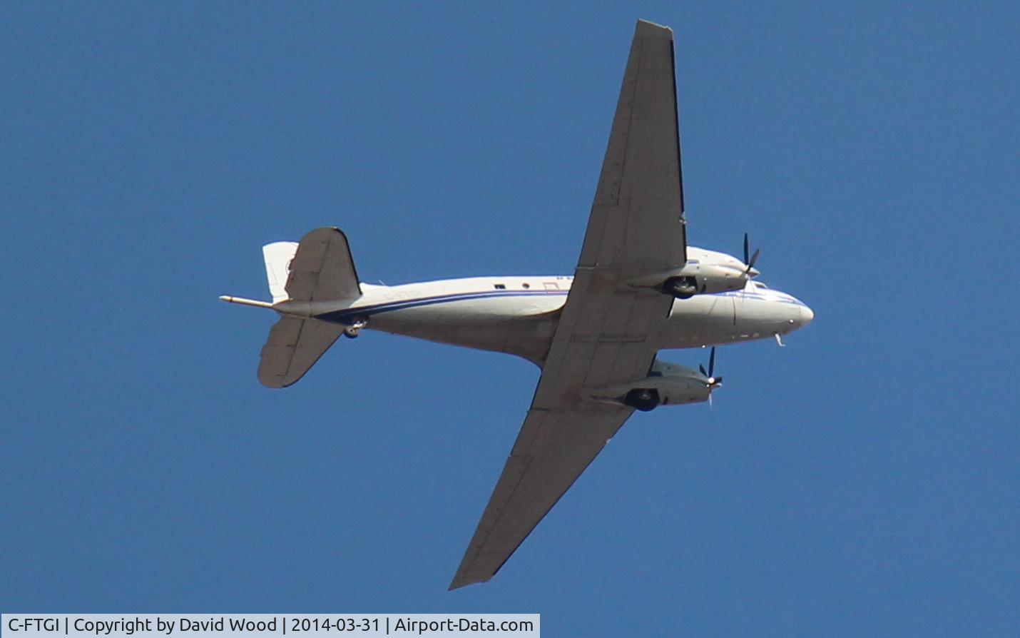 C-FTGI, 1944 Basler BT-67 C/N 26268, Beautiful plane!  This one flew over me twice just after 15:00 Hrs EDT on March 31st, 2014... this was the second pass.  This shot was taken in Whitby Ontario, and was likely heading into the Oshawa Airport.