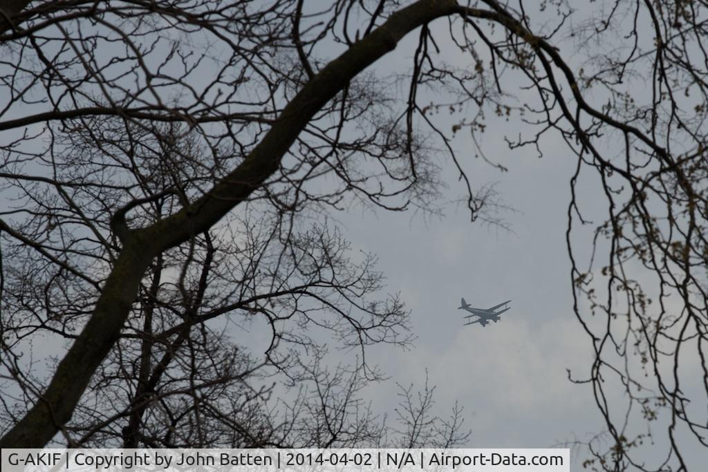 G-AKIF, 1944 De Havilland DH-89A Dominie/Dragon Rapide C/N 6838, G-AKIF over Central London seen through the appropriately named plane trees in Bloomsbury Square Gardens
