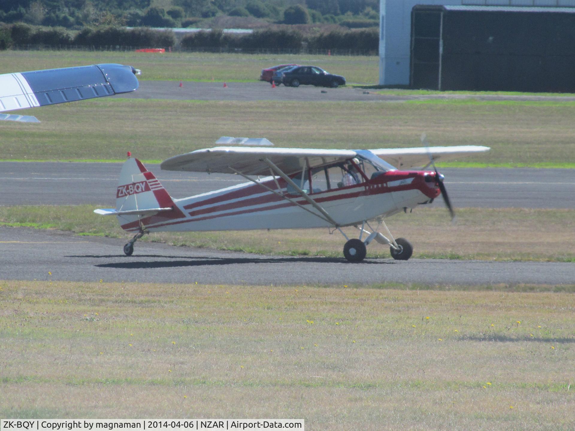 ZK-BQY, Piper PA-18 C/N 18-5769, BIt of a long shot as it lands
