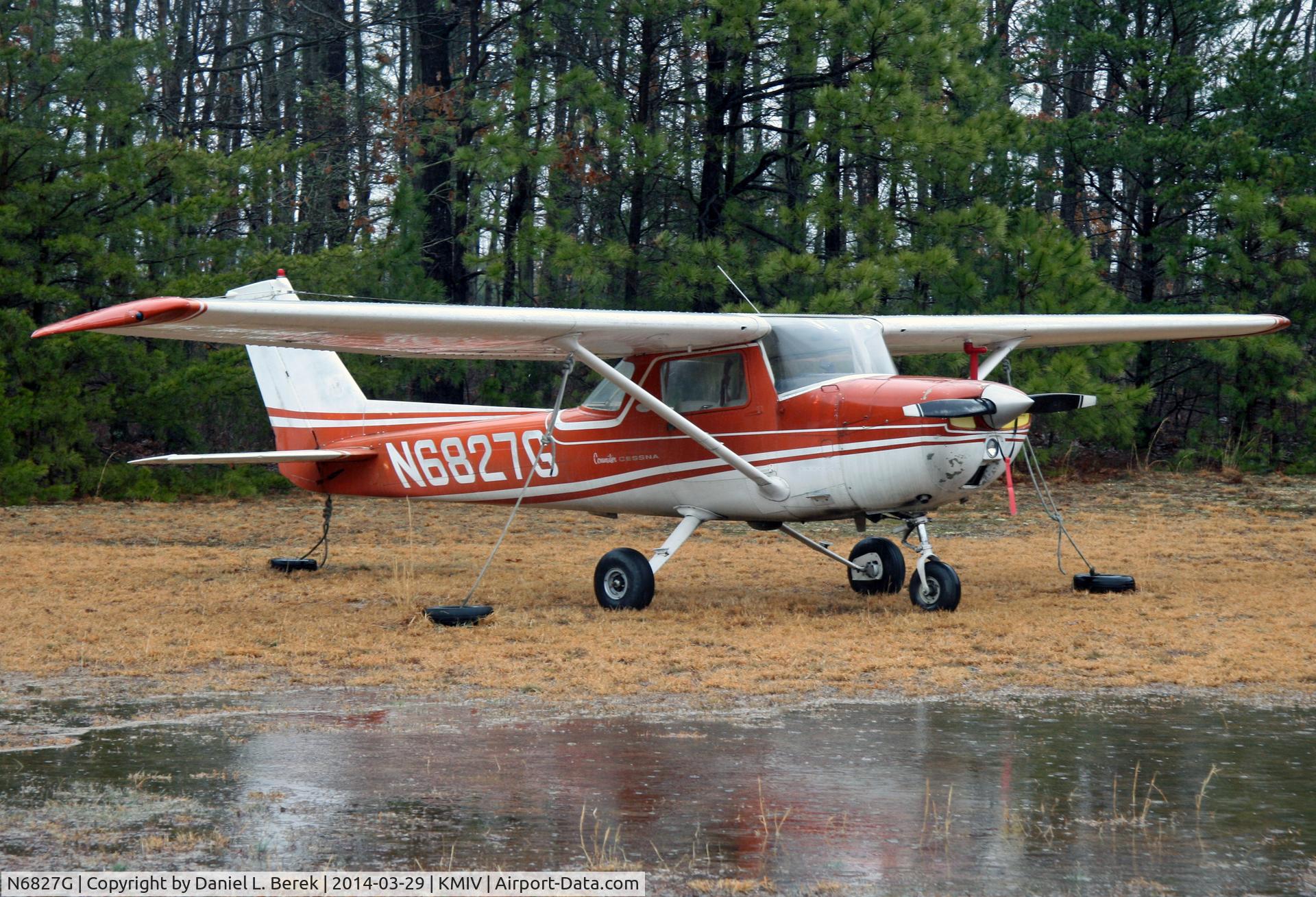 N6827G, 1970 Cessna 150L C/N 15072327, This poor, wet Cessna 150 appears to be losing the battle in keeping dry on this dark, wet Saturday morning.