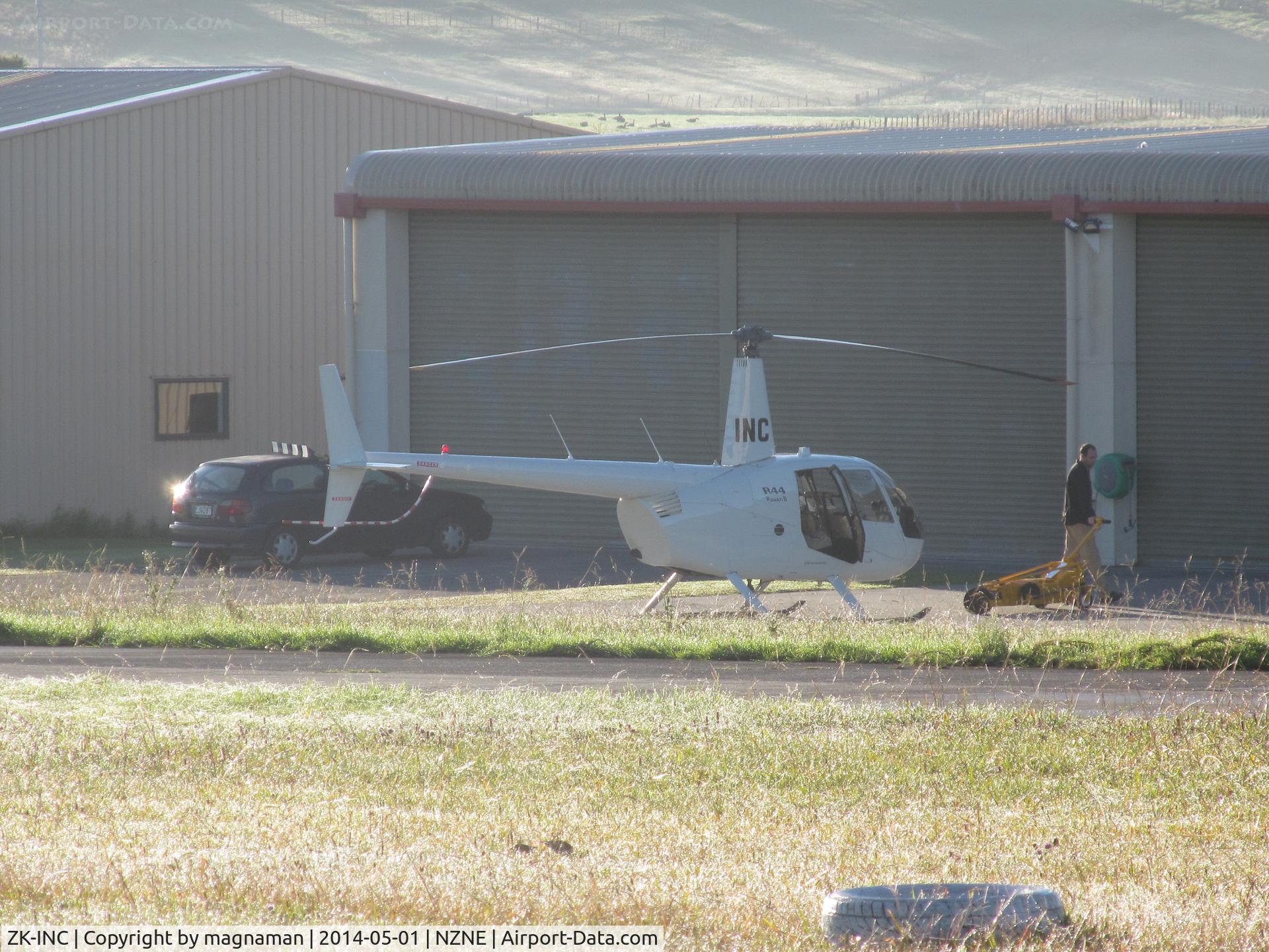 ZK-INC, 2006 Robinson R44 Raven II C/N 10940, wider angle view in front of the rows of private hangars. Looked like at least three other helicopters in same hangar including ZK-HPT