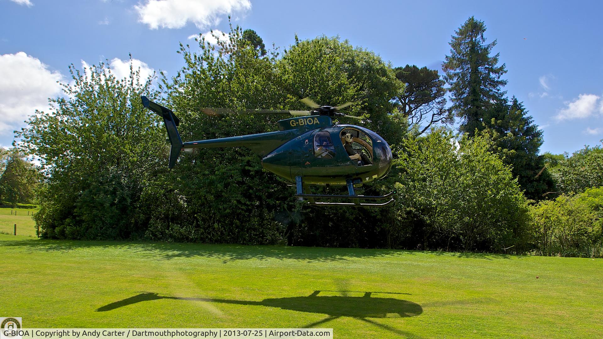 G-BIOA, 1980 Hughes 369D C/N 1200880D, Landing at Private site just outside Plymouth, Devon. Heavily disguised in front of the foliage