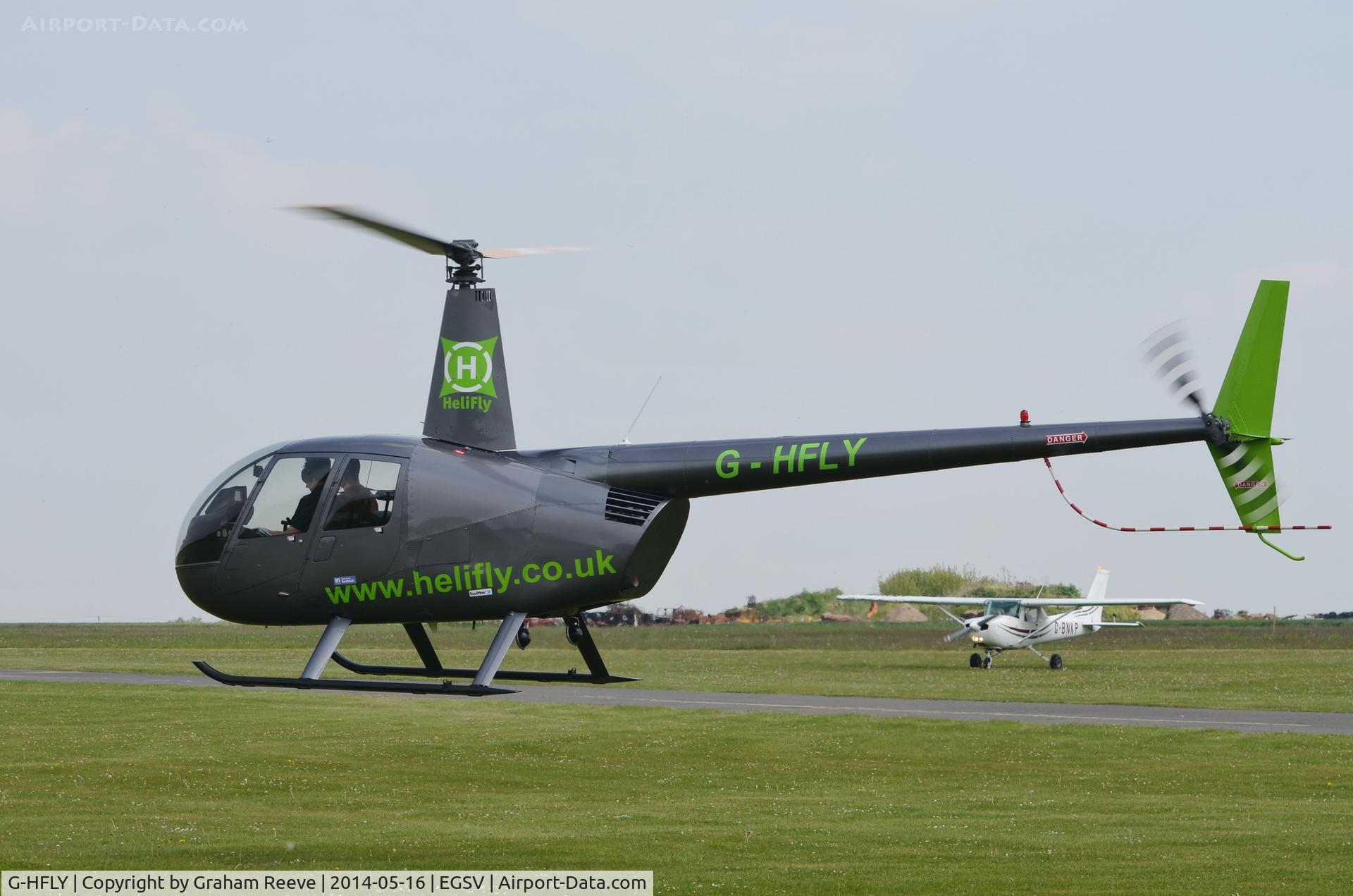 G-HFLY, 2007 Robinson R44  Raven II C/N 11876, About to touch down.