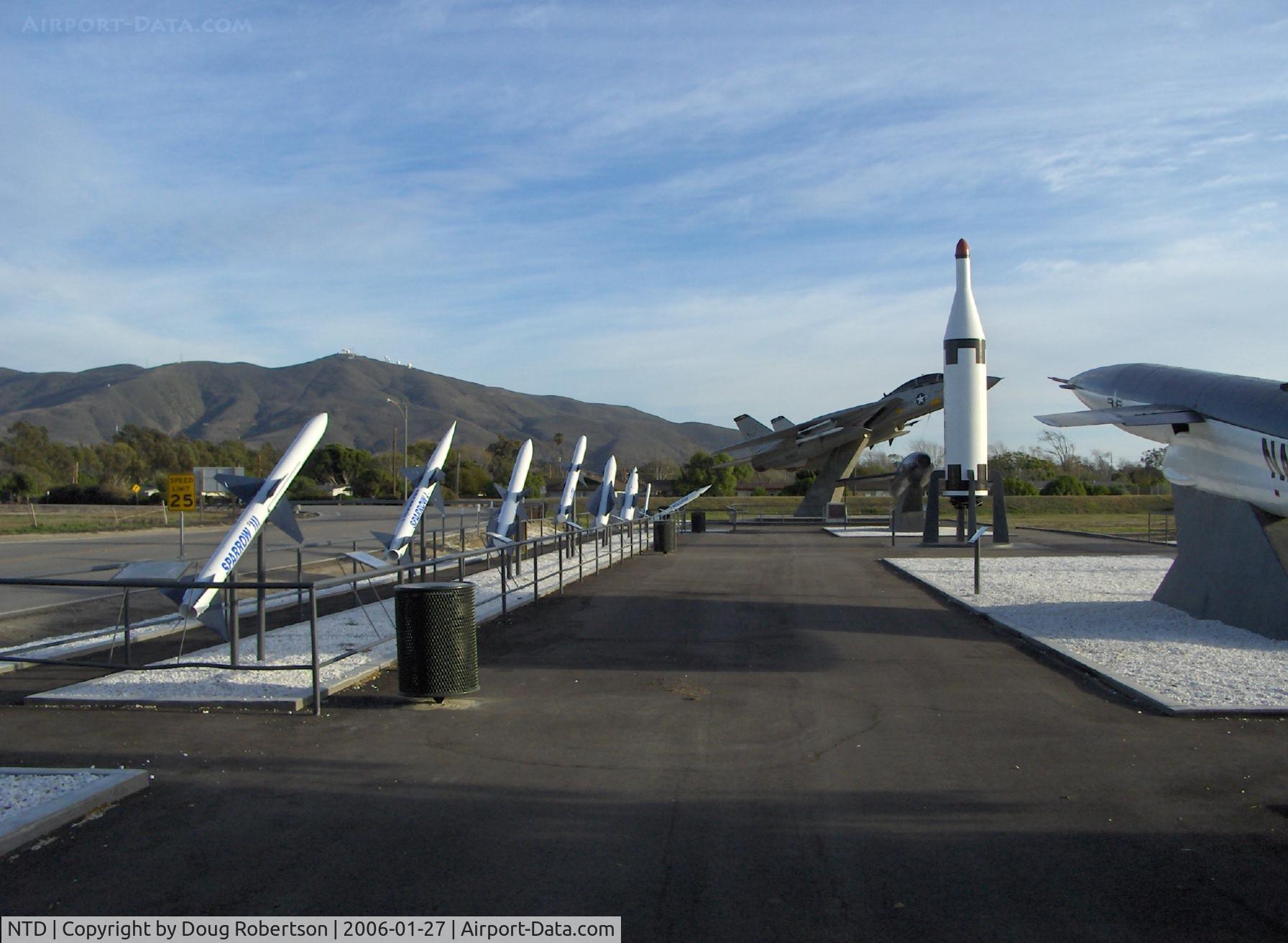 Point Mugu Nas (naval Base Ventura Co) Airport (NTD) - Missile Park, mounted F-14A TOMCAT BuNo.158623, tall vertical POLARIS, Point Mugu housing and 1,567 ft. instrumented Laguna Peak in background