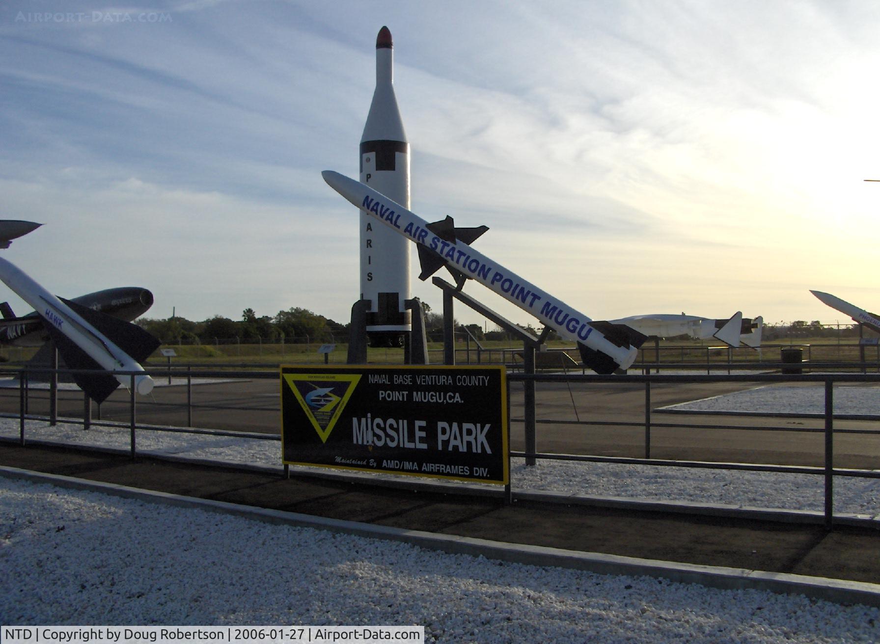 Point Mugu Nas (naval Base Ventura Co) Airport (NTD) - Missile Park, AGM-88 HARM Missile (as sign) foreground, and Main sign on Navalair Road-Naval Base Wood Road access turnoff from Pacific Coast Highway, Point Mugu, California. I managed HARM at Pt. Mugu-1983 to my 1995 retirement.