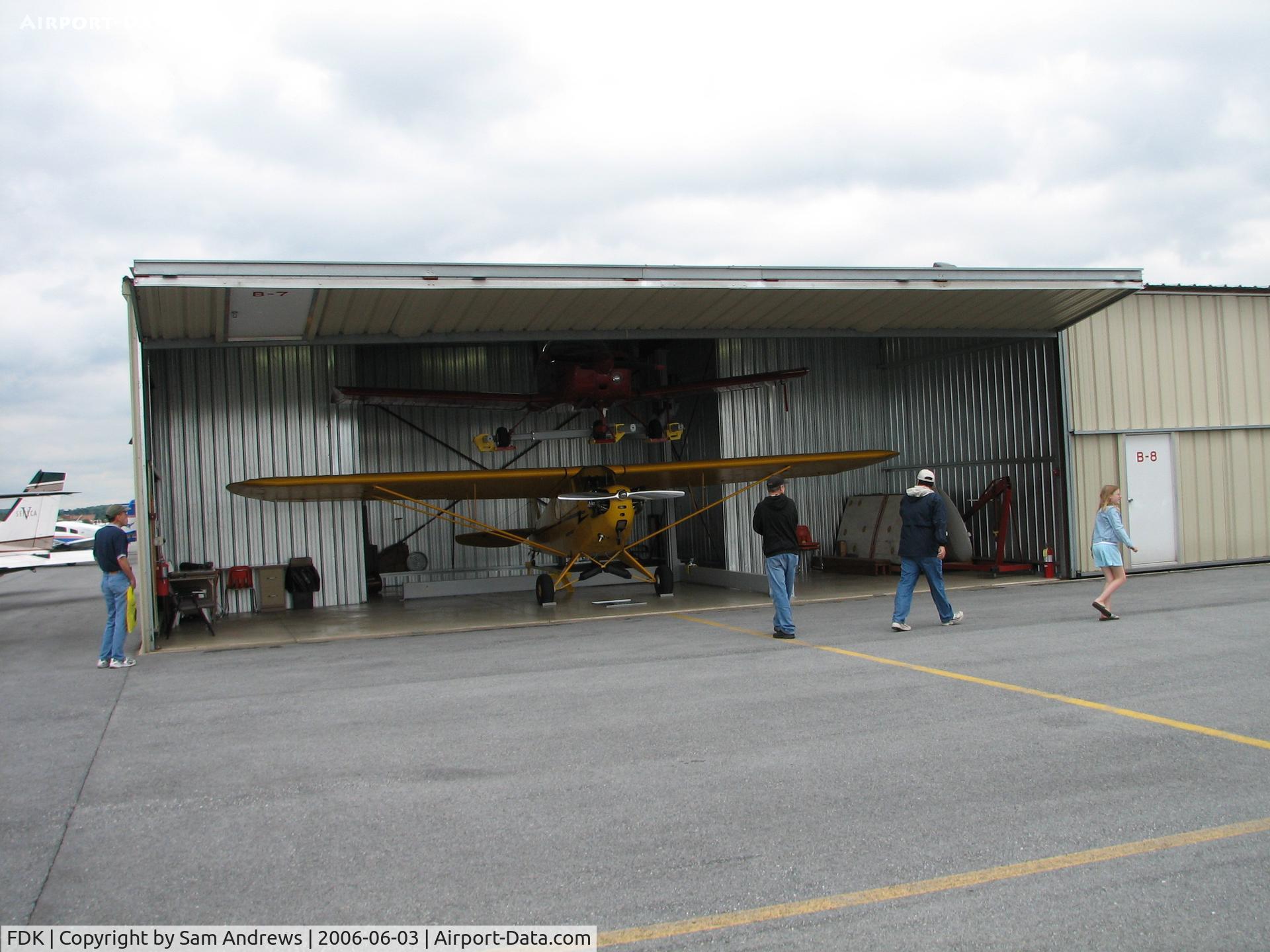 Frederick Municipal Airport (FDK) - This guy had his hangar open so I took the shot.  That's what looked to me to be an old grumman cheetah on top but I'm not positive.