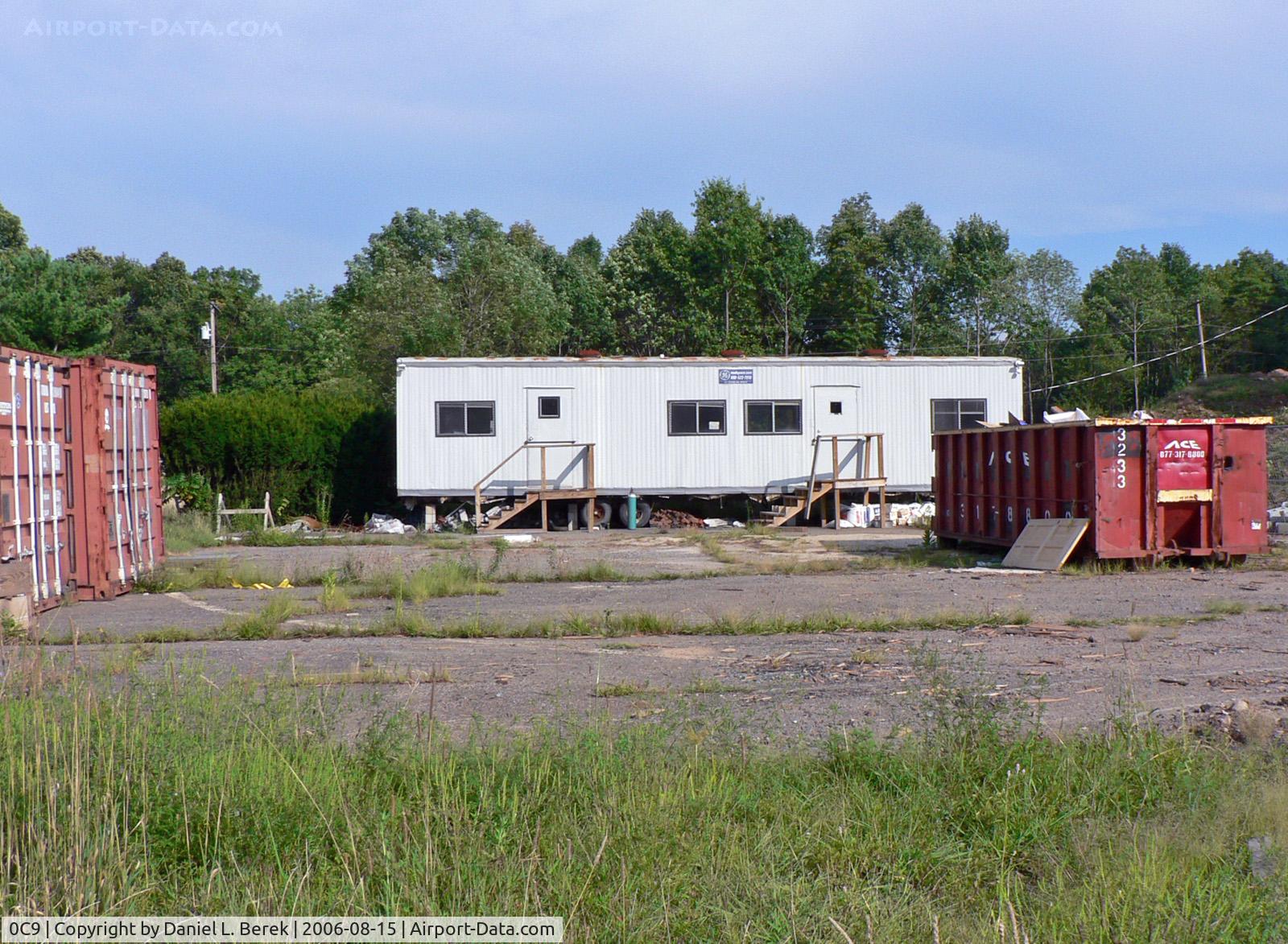 0C9 Airport - Construction trailers and containers occupy what was once the pad for the Coach & Paddock heliport. The restaurant has a different name and is being renovated.