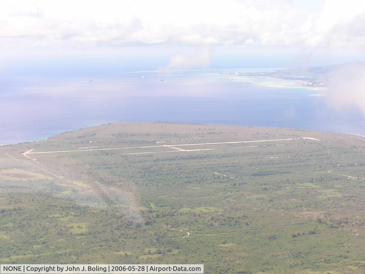 NONE Airport - Unused WW2 airfied on northern end of Tinian, Saipan in upper right of photo