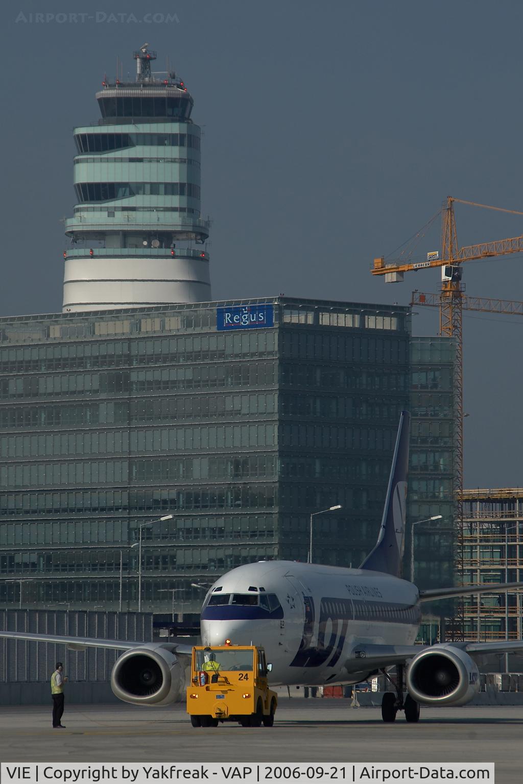 Vienna International Airport, Vienna Austria (VIE) - LOT Boeing 737 pushing back infront of the office park and the control tower