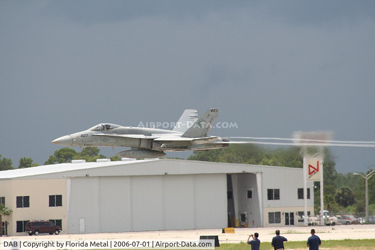 Daytona Beach International Airport (DAB) - Yelvington Hangar with an F-18 taking off in front of it