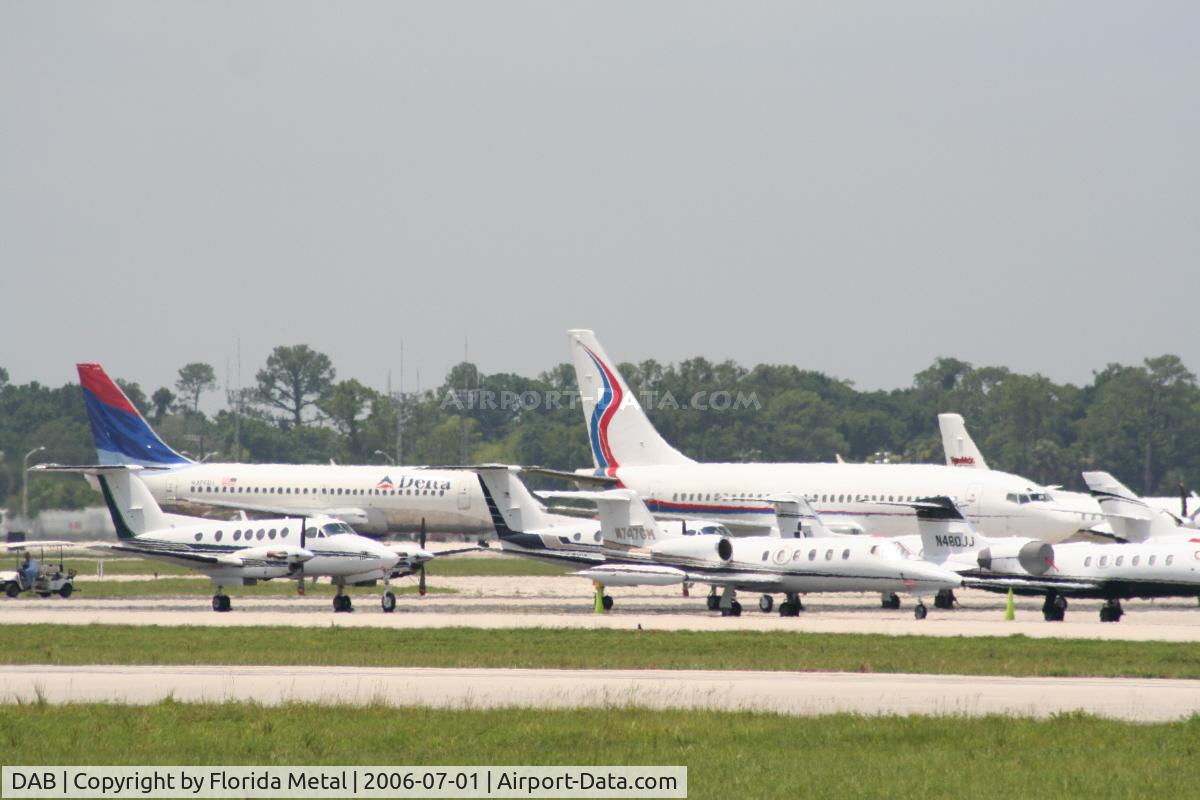 Daytona Beach International Airport (DAB) - Delta aircraft arrives in background of a big group of parked planes for the race
