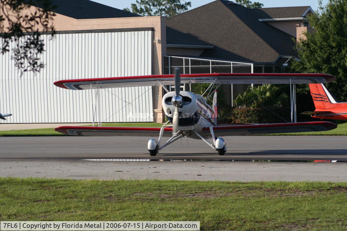 Spruce Creek Airport (7FL6) - Bi plane with private hangars in background