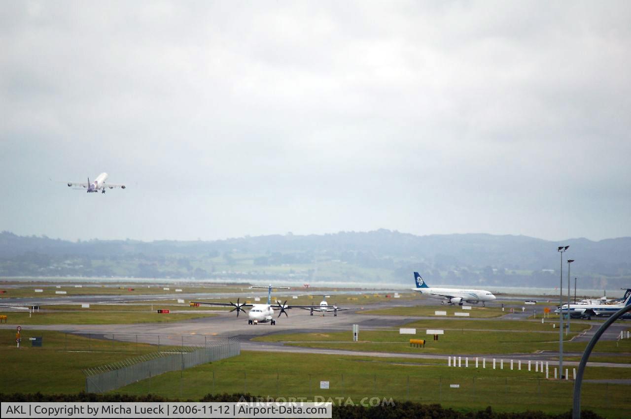 Auckland International Airport, Auckland New Zealand (AKL) - A340-600 HS-TND (Thai Airways) is climbing into the sky, while some Air NZ aircraft (ATR 72-500, Beech 1900D, A320-200) are taxiing...