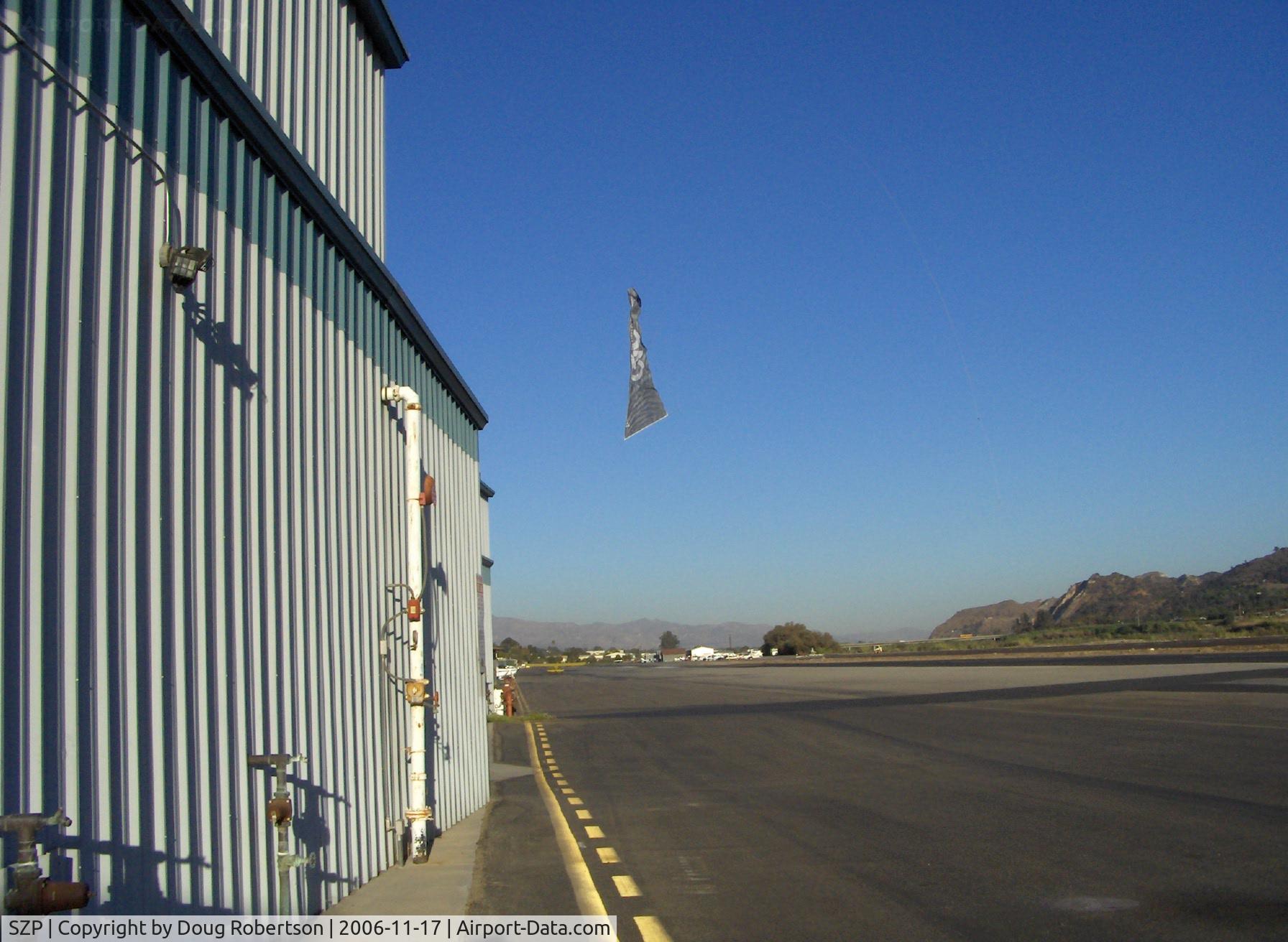 Santa Paula Airport (SZP) - Banner Tow Release/Drop over taxiway by N3042M Piper Super Cruiser with 180 Hp, Note the taxying aircraft-usually the drop is on other side of Runway 22