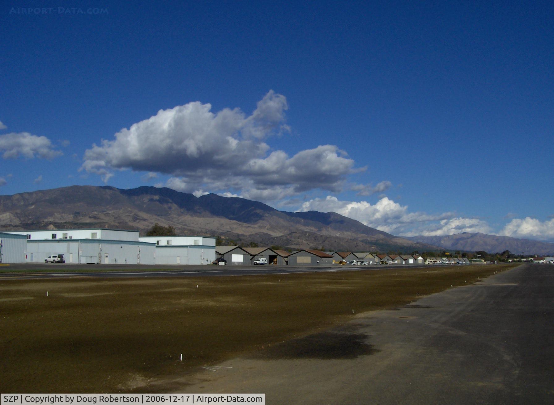 Santa Paula Airport (SZP) - Newer & Old Hangars, Santa Paula Peak in background. Elevation: 4,917 ft.
