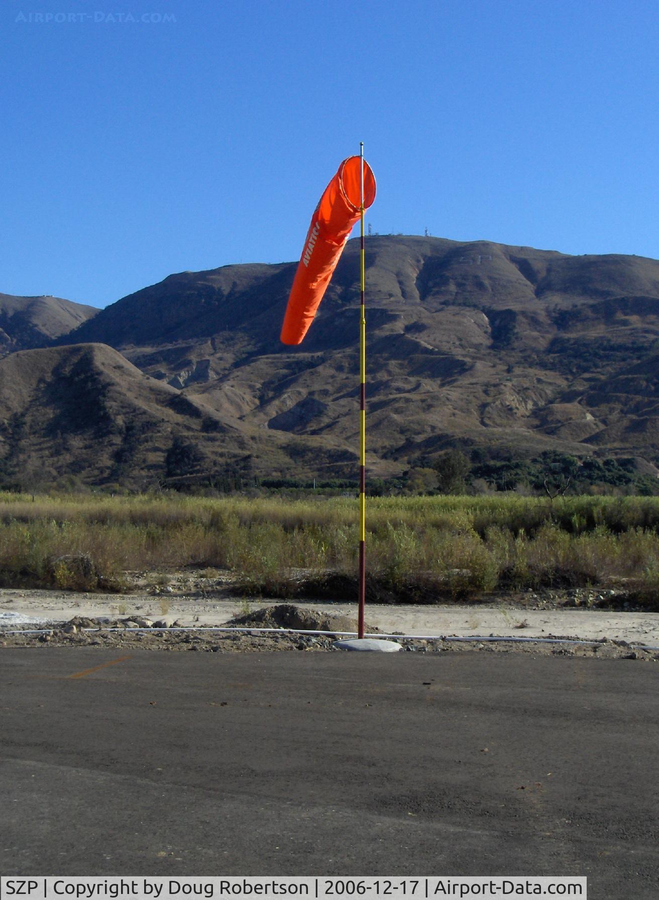 Santa Paula Airport (SZP) - Windsock, Runway 04 end of 04-22, Santa Clara Riverbed, South Mountain in background. Elevation: 2,263 ft. South Mountain marks the western terminus of the Santa Susana Mountain Range.