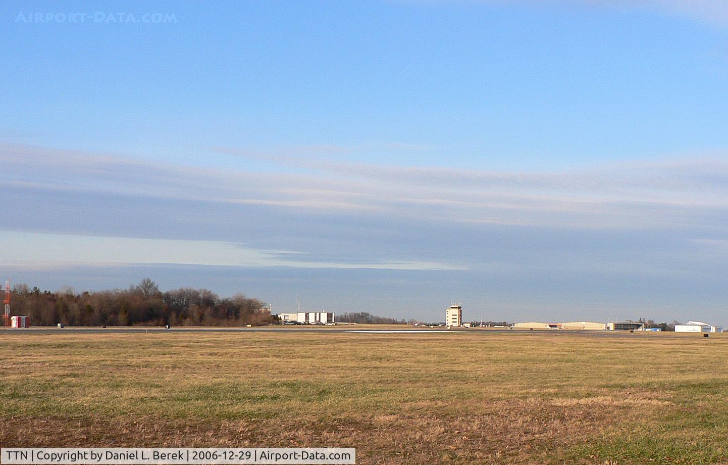 Trenton Mercer Airport (TTN) - This view, taken from a nearby residential neighborhood, shows Runway 6, with the control tower, general aviation facilities, and the New Jersey State Police heliport.