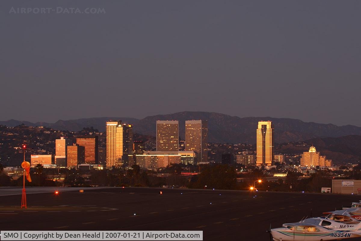 Santa Monica Municipal Airport (SMO) - View looking northeast toward the approach end of RWY 21, with the buildings of Century City beautifully lit from the orange sky after sunset.
