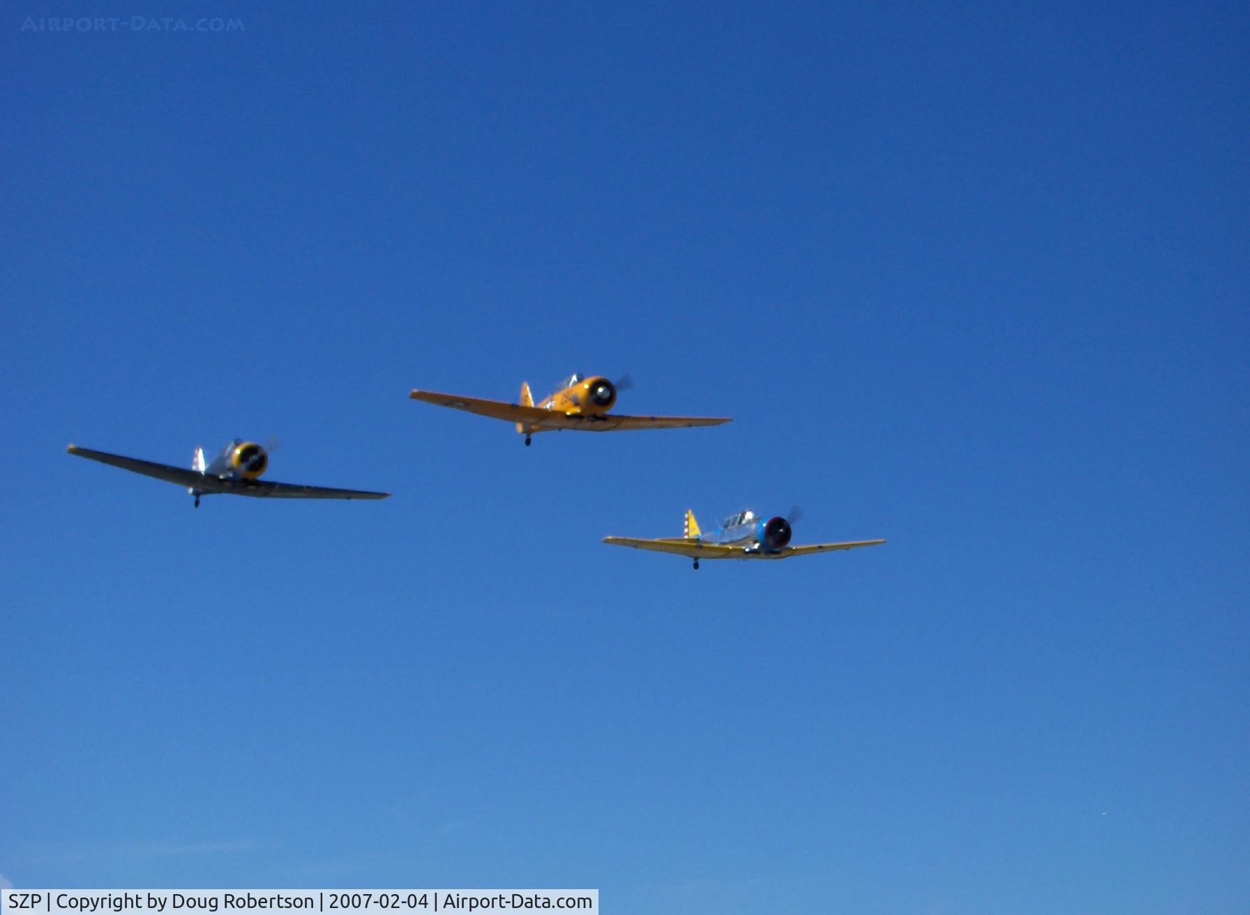 Santa Paula Airport (SZP) - N8540P AT-6D 'Miss Universe', N89014 SNJ-5, N4995C 'Thirsty Girl' vee formation flyover at speed Runway 04 (very nice on the photographer's birthday!)