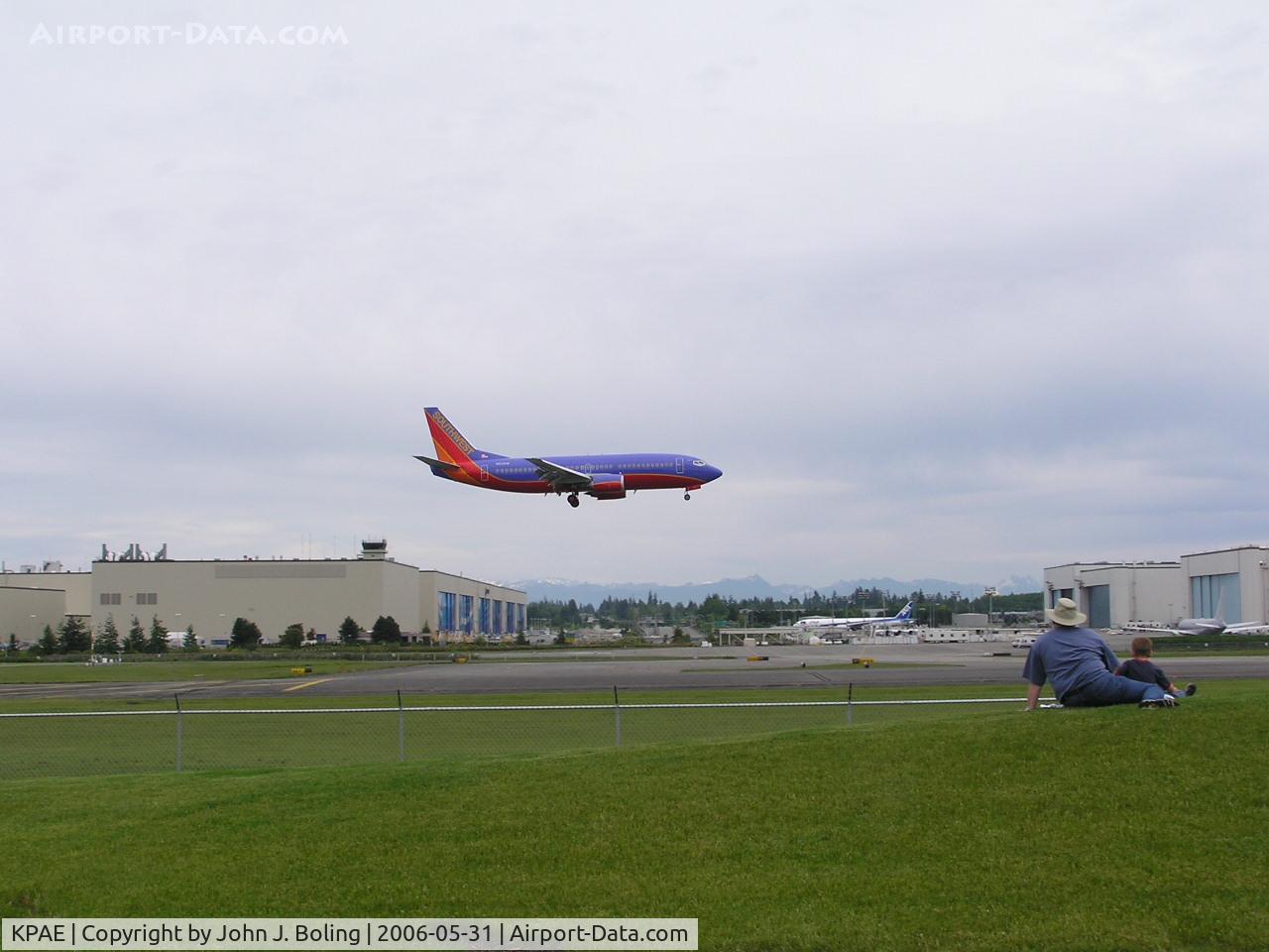 Snohomish County (paine Fld) Airport (PAE) - Southwest 737 landing 16R, Boeing wide body plant background left, paint hangars background right