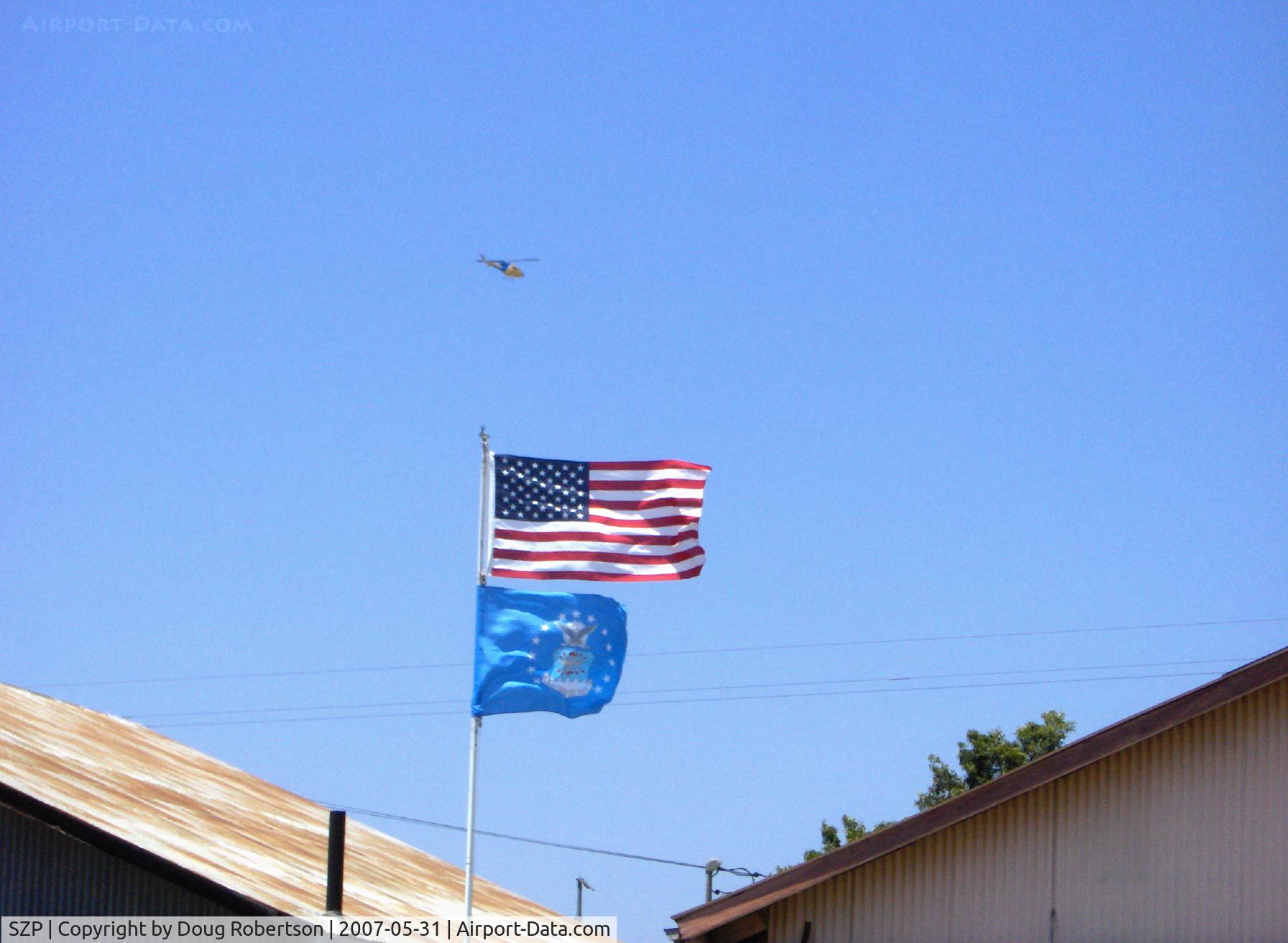 Santa Paula Airport (SZP) - Ventura County Sheriff's Dept. Helicopter on continuous circular orbit search with high speed auto chase of felony warrant suspect over Santa Paula. One arrested, one escaped.