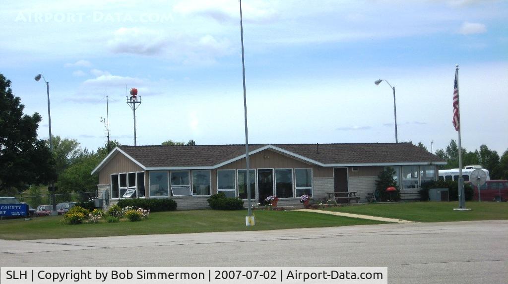 Cheboygan County Airport (SLH) - Terminal at Cheboygan, MI.  Friendly airport and reasonable (relatively speaking) self-serve fuel prices.
