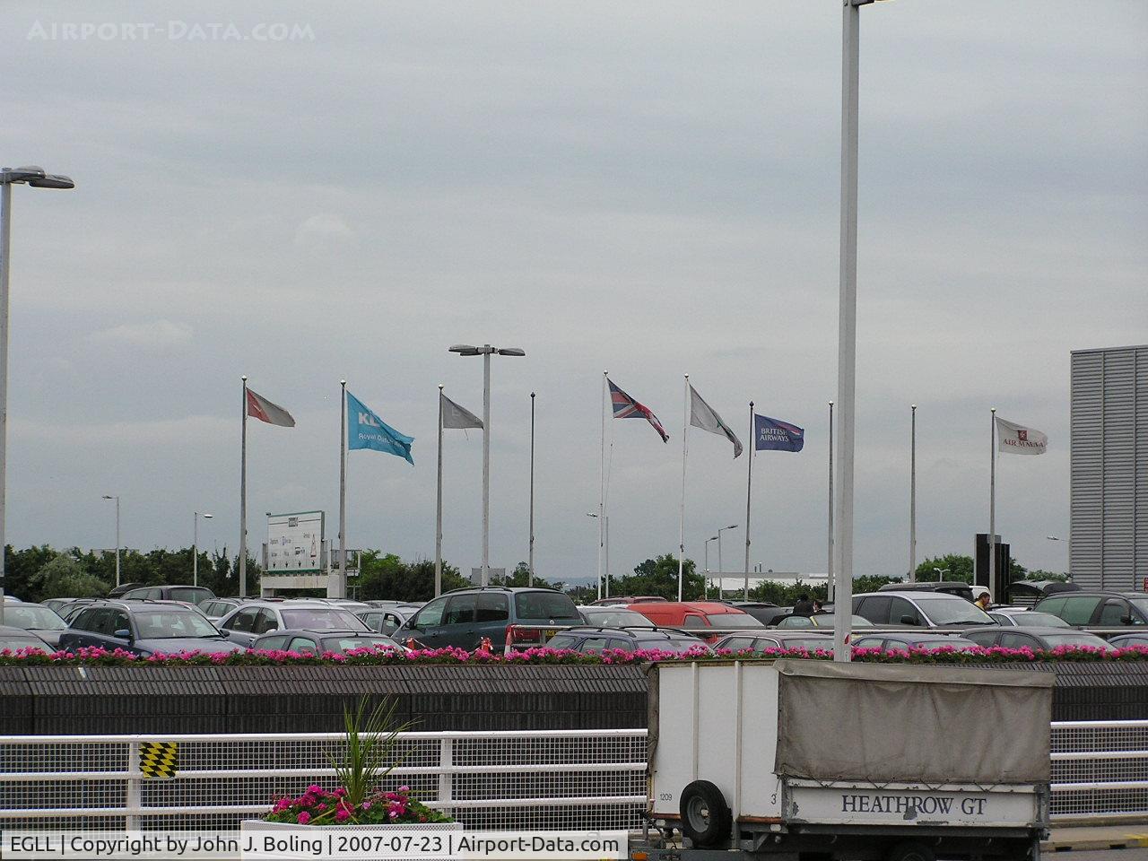 London Heathrow Airport, London, England United Kingdom (EGLL) - Airline Flags outside Terminal 4 at Heathrow