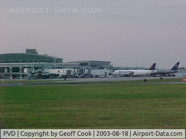 Theodore Francis Green State Airport (PVD) - The unusual sight of a an Air Luxor A320 next to a United 757 at the terminal in Providence