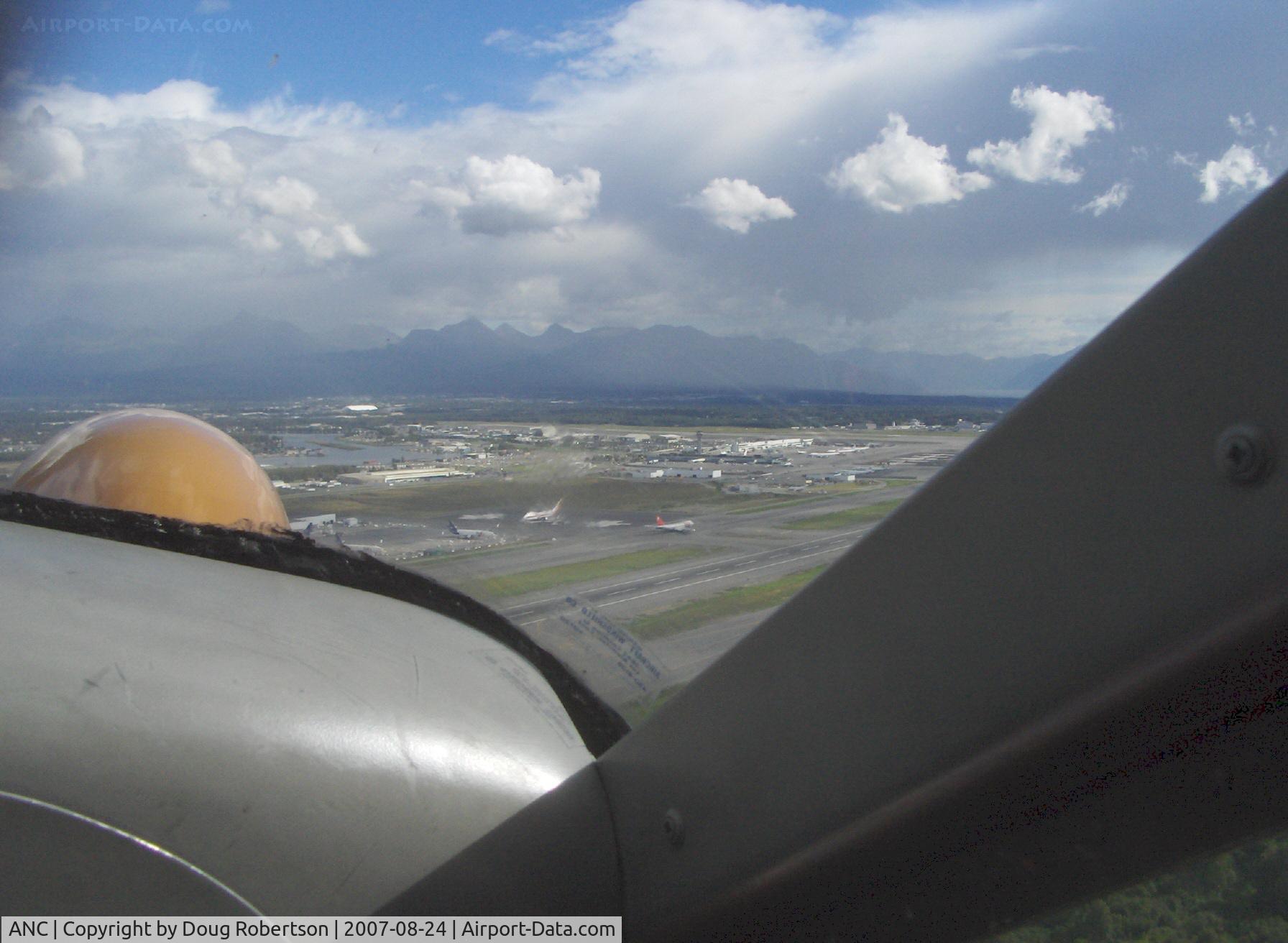Ted Stevens Anchorage International Airport (ANC) - Ted Stevens Anchorage Int'l Airport, AK. Taken from DHC-2 Beaver float plane N4444Z. Chugach State Park and Mountain Range in distance.