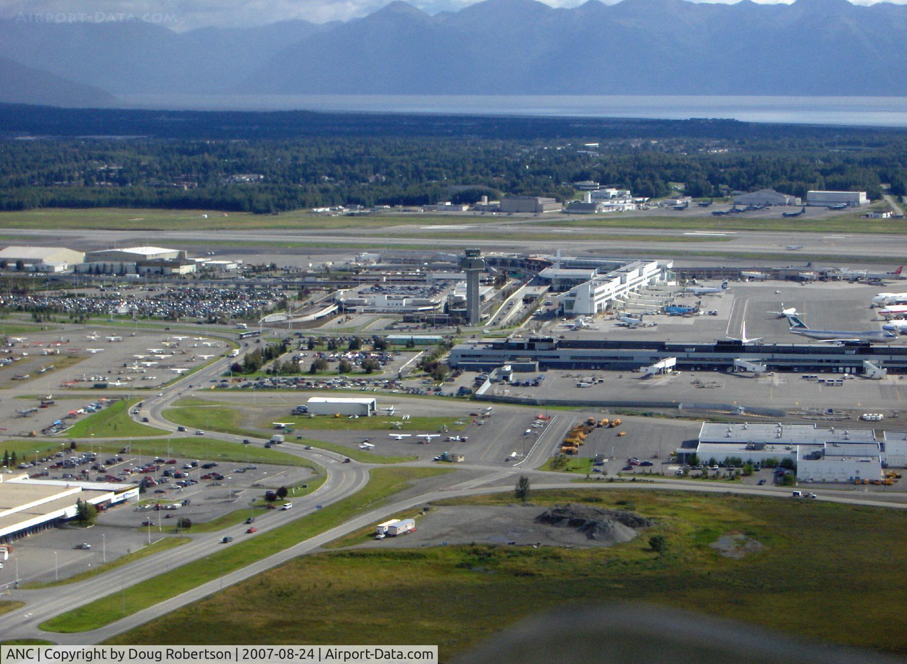 Ted Stevens Anchorage International Airport (ANC) - Approaching abeam ANC Tower and South Terminal for landing Lake Hood Sea Plane Base LHD. Water in distance is Turnagain Arm. Taken from copilot's seat DHC-2 Beaver float plane N4444Z.